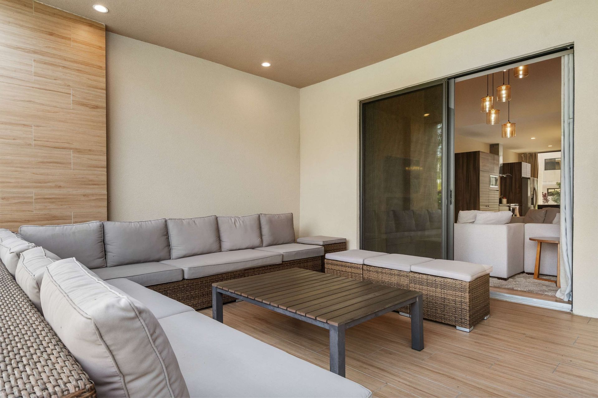 Relaxing patio lounge with ample seating, modern decor, and direct indoor access

