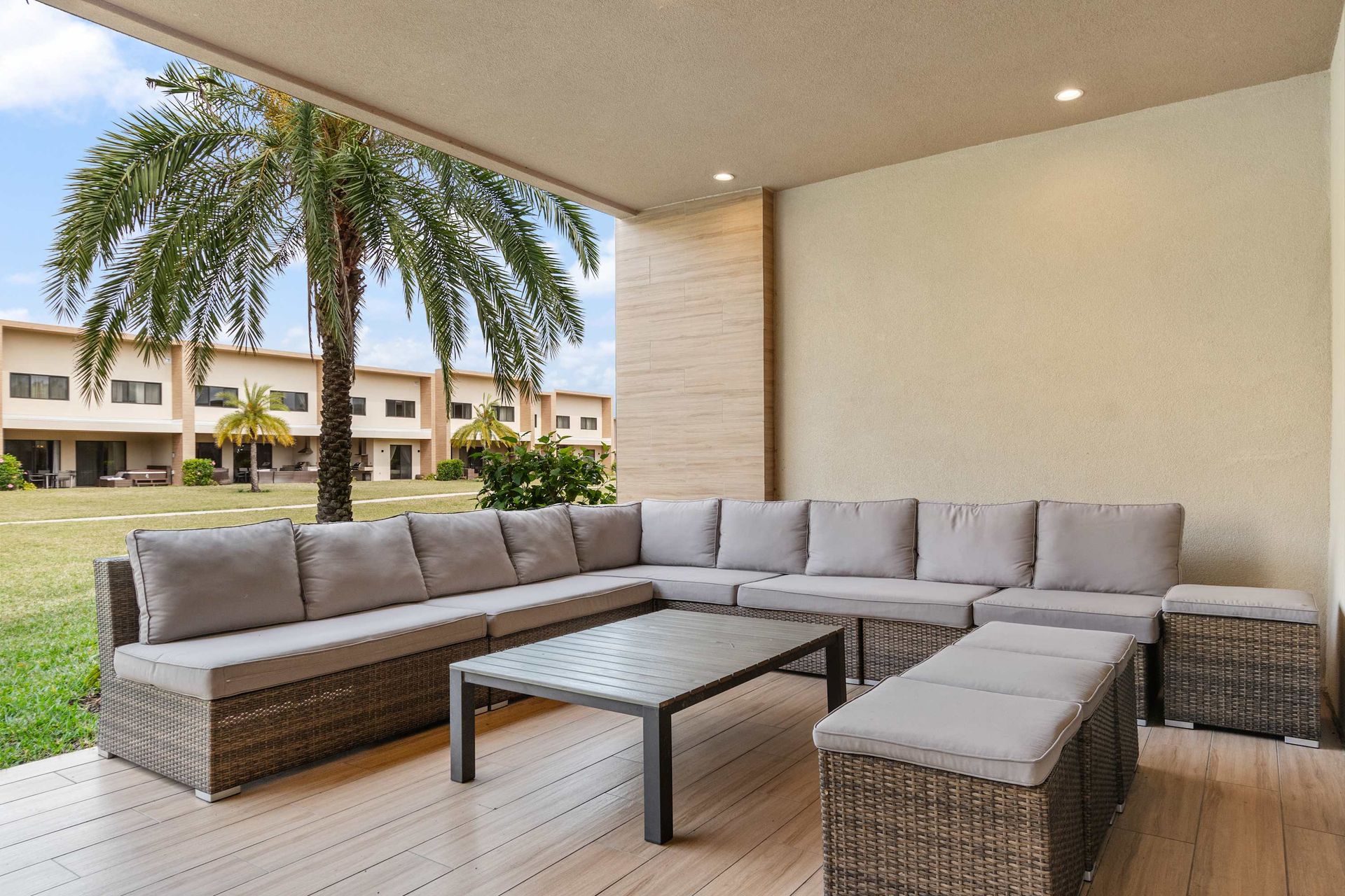 Spacious covered patio with sectional seating, perfect for relaxing and entertaining
