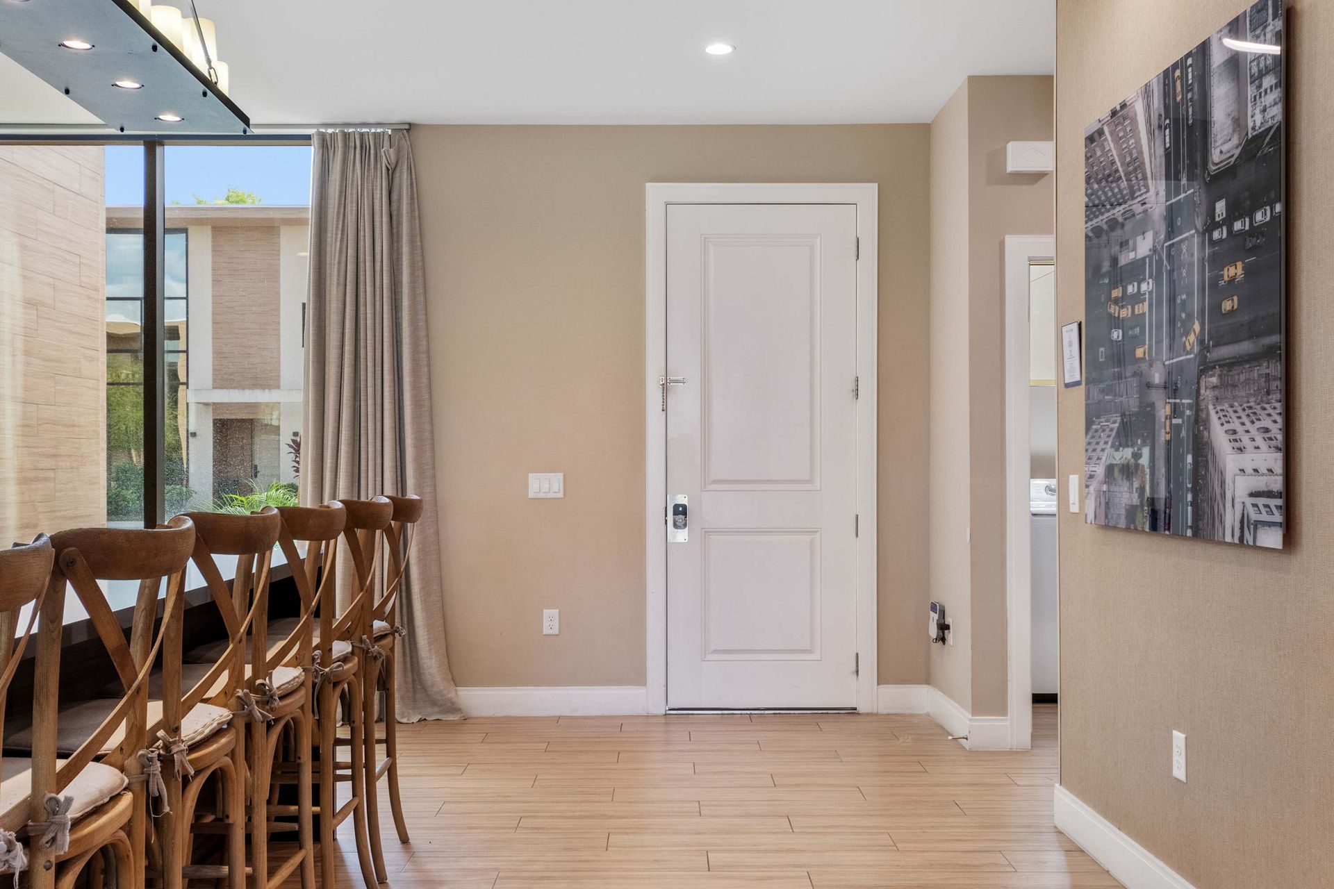 Bright entryway with modern finishes, wood-look flooring, and natural light accents
