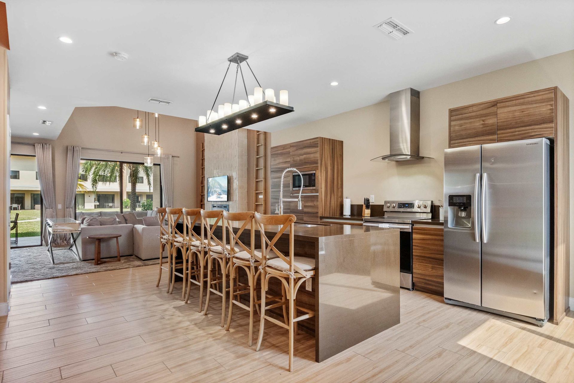 Sleek chef’s kitchen with island seating, open layout, and modern finishes
