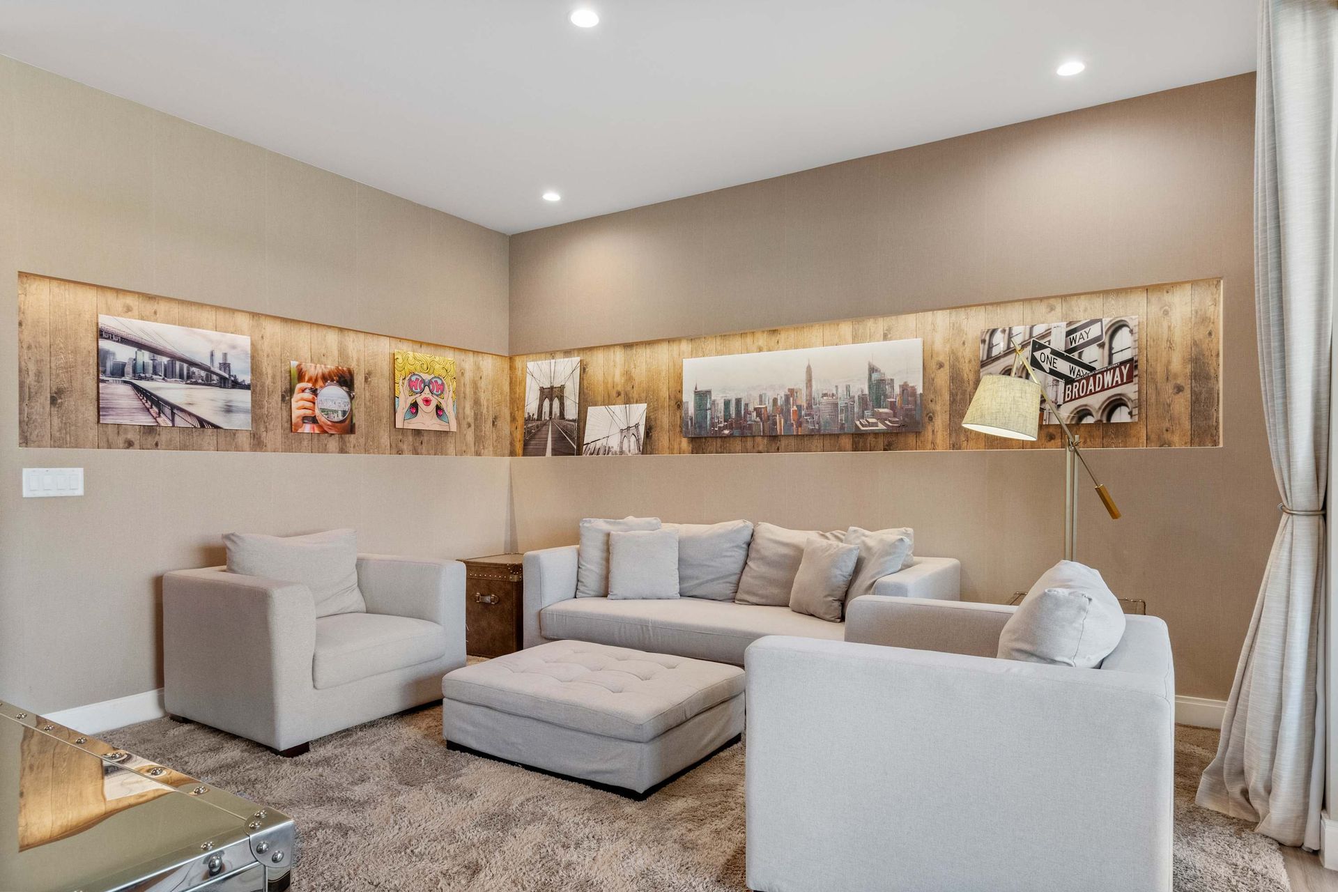 Cozy media nook with modern art, plush sectional, and warm ambient lighting
