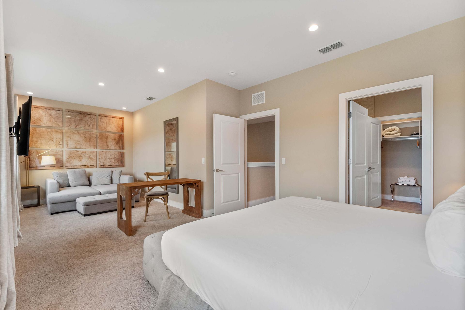 Luxurious primary suite with lounge, walk-in closet, workspace, and cozy ambiance

