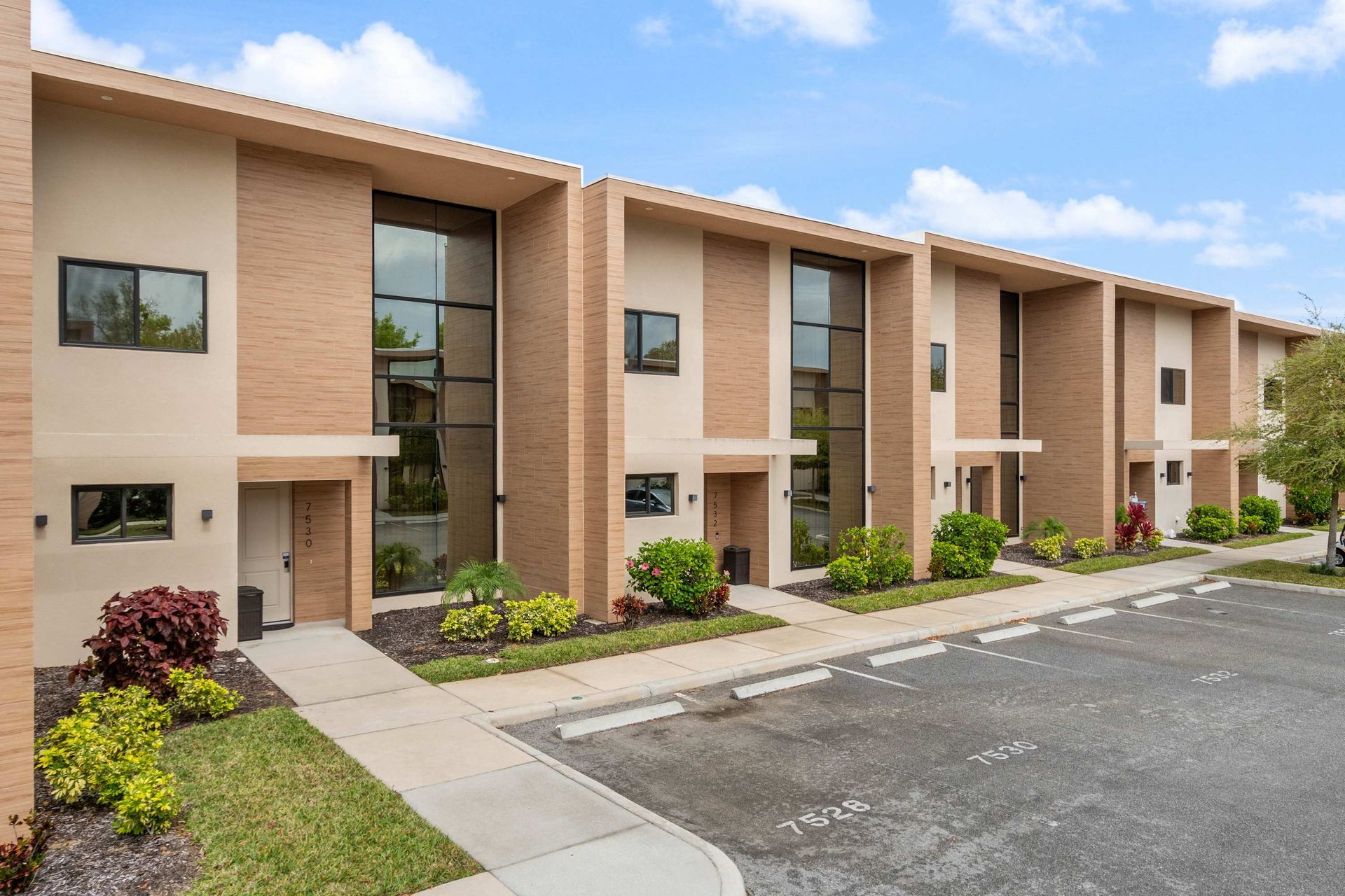 Contemporary townhomes with floor-to-ceiling windows, private entries, and parking
