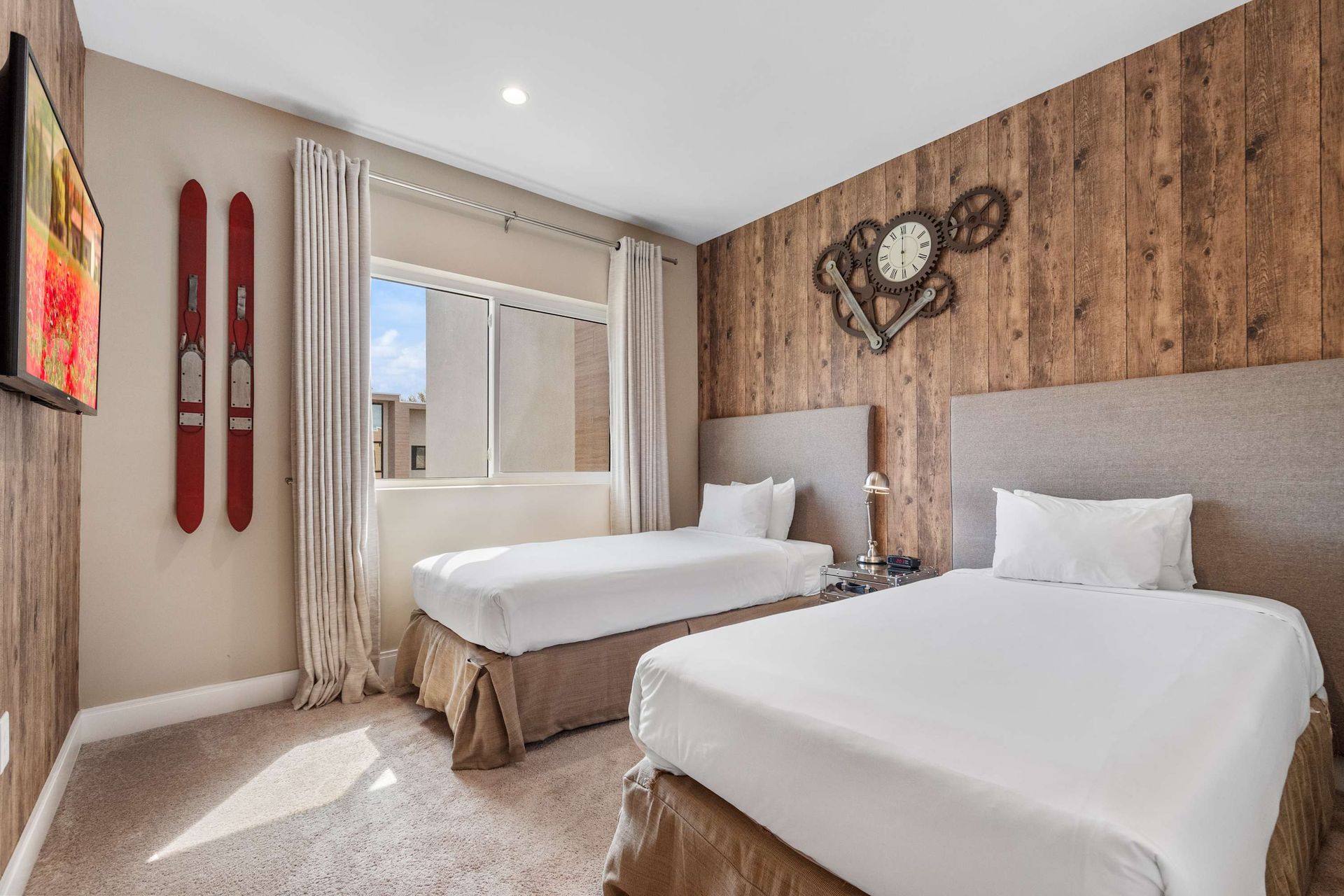 Charming twin room with rustic wood accents, vintage decor, and natural light
