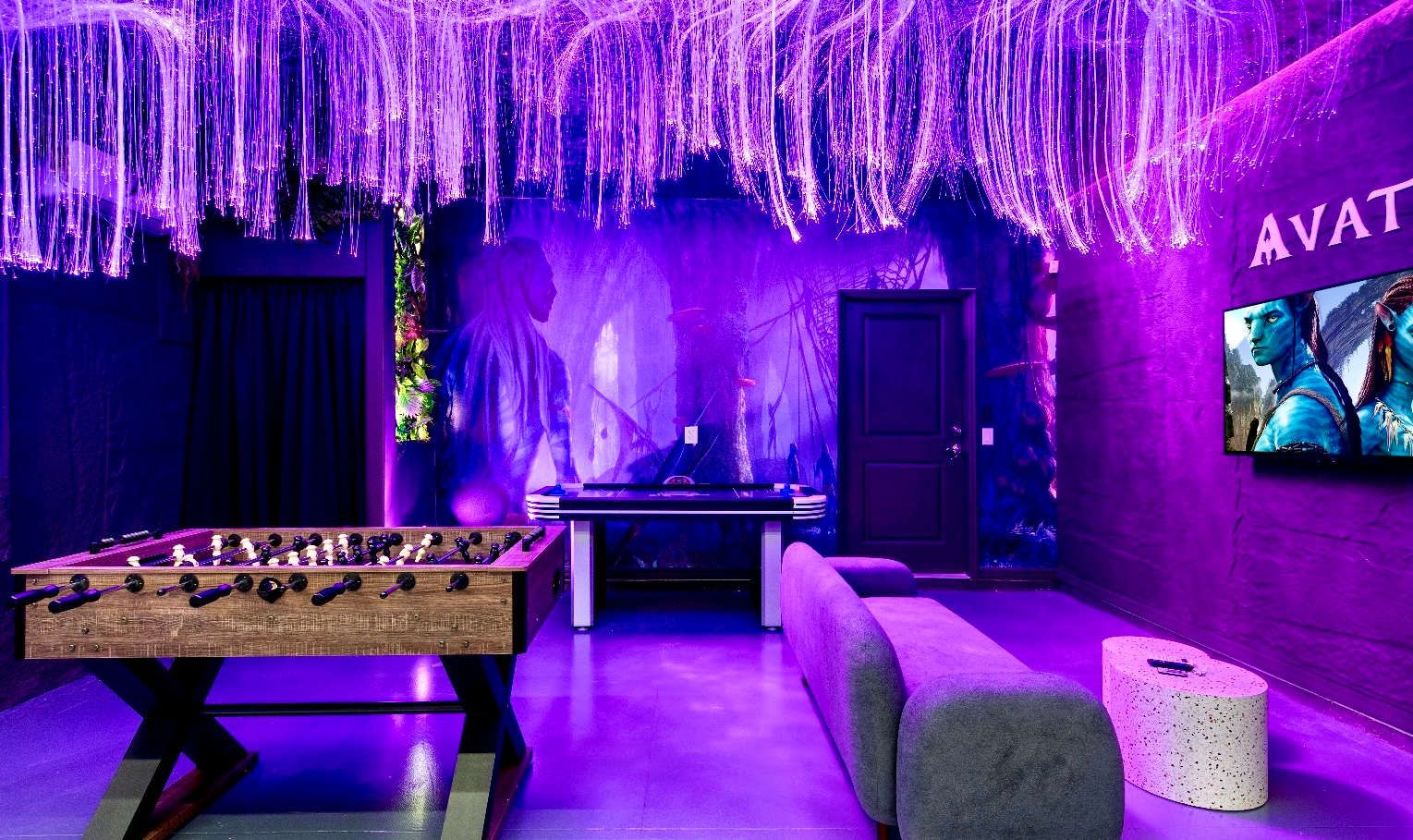 Avatar-themed game room with foosball, air hockey, and glowing Pandora vibes.
