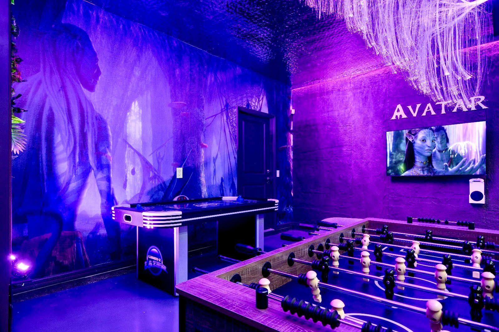 Avatar-themed game room with foosball, air hockey, and glowing Pandora vibes.