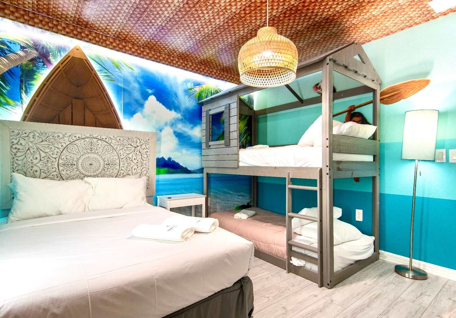 Tropical island-themed room with bunk beds, surf vibes, and coastal charm.