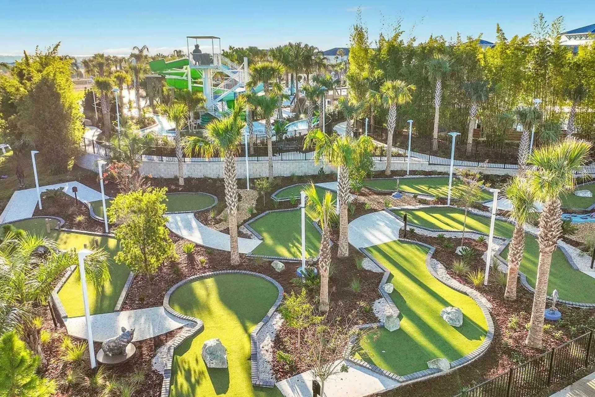Luxury resort clubhouse with lazy river, splash zone, water slides, pool, and mini golf.