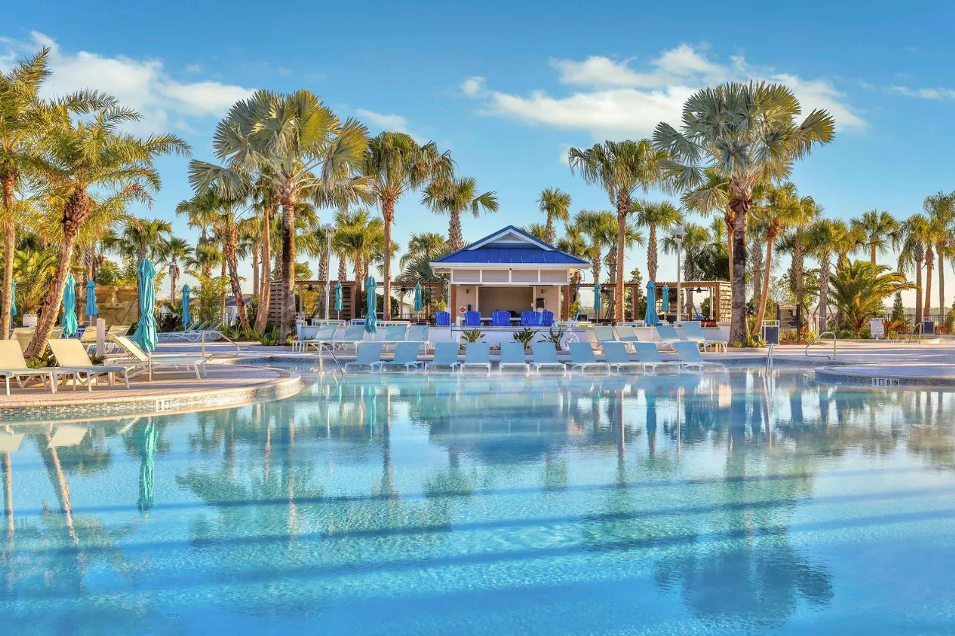 Soak up paradise poolside with palm trees, blue skies, and hot air balloon views.