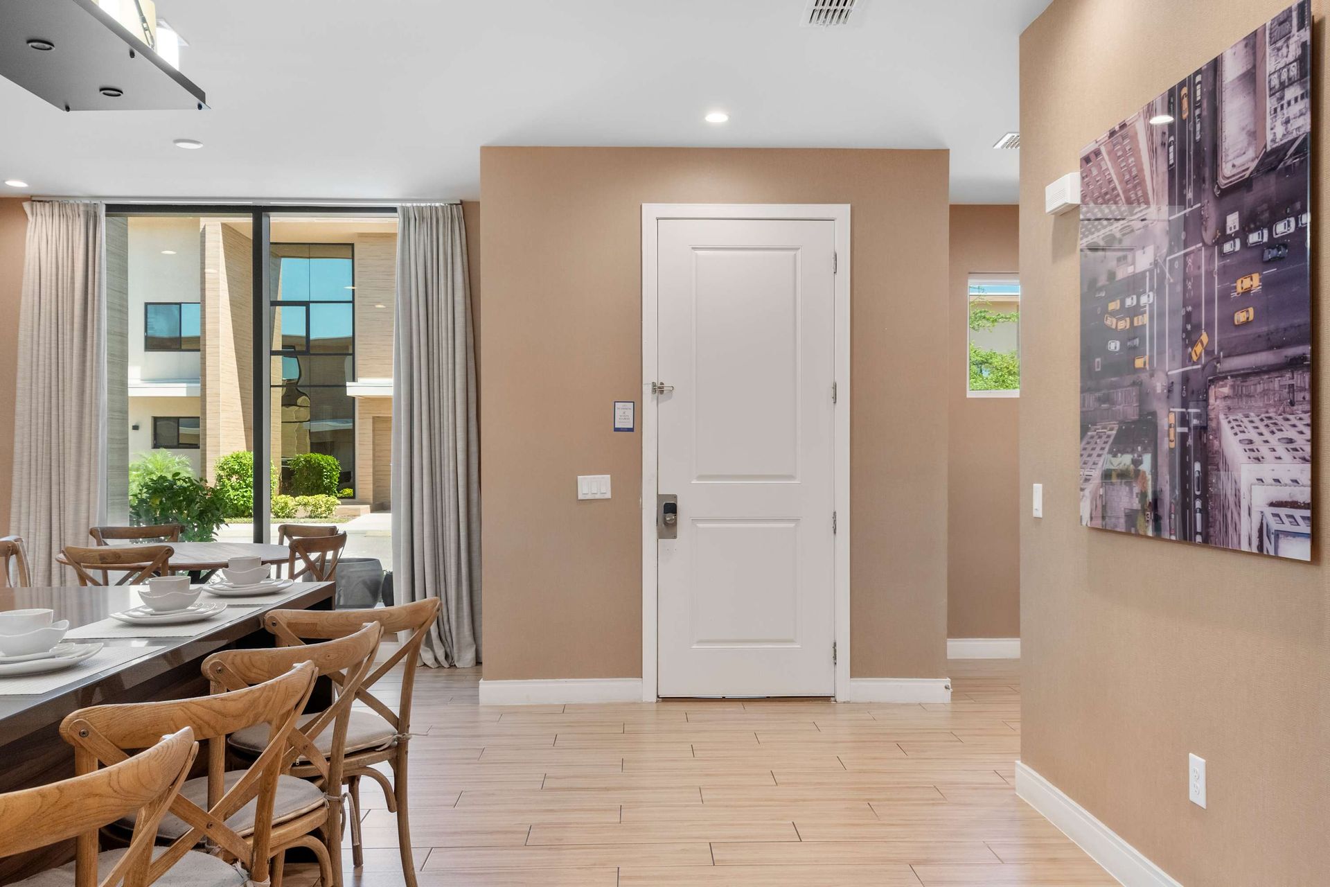 Inviting entryway with modern finishes, wall art, and views of the bright interior
