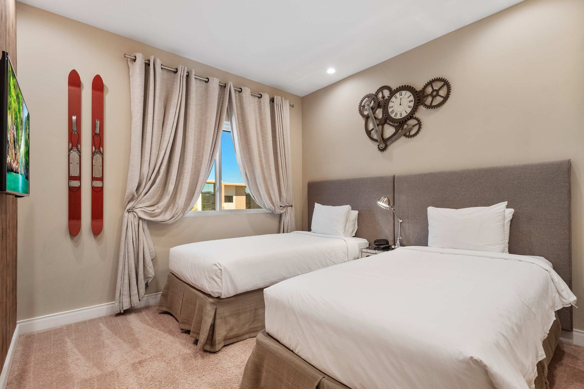 Inviting twin bedroom with soft tones, ski-themed decor, and cozy natural light
