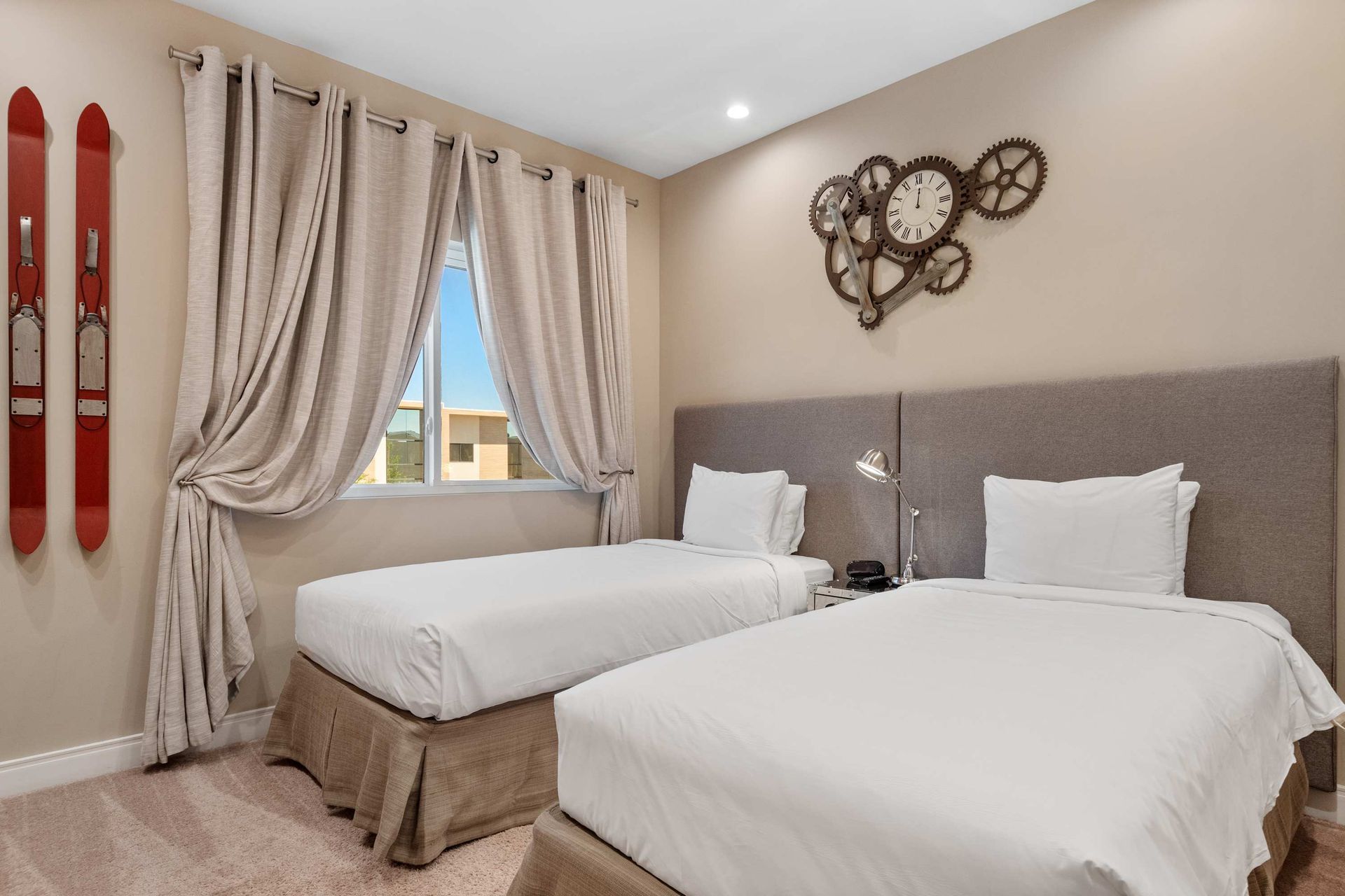 Inviting twin bedroom with soft tones, ski-themed decor, and cozy natural light
