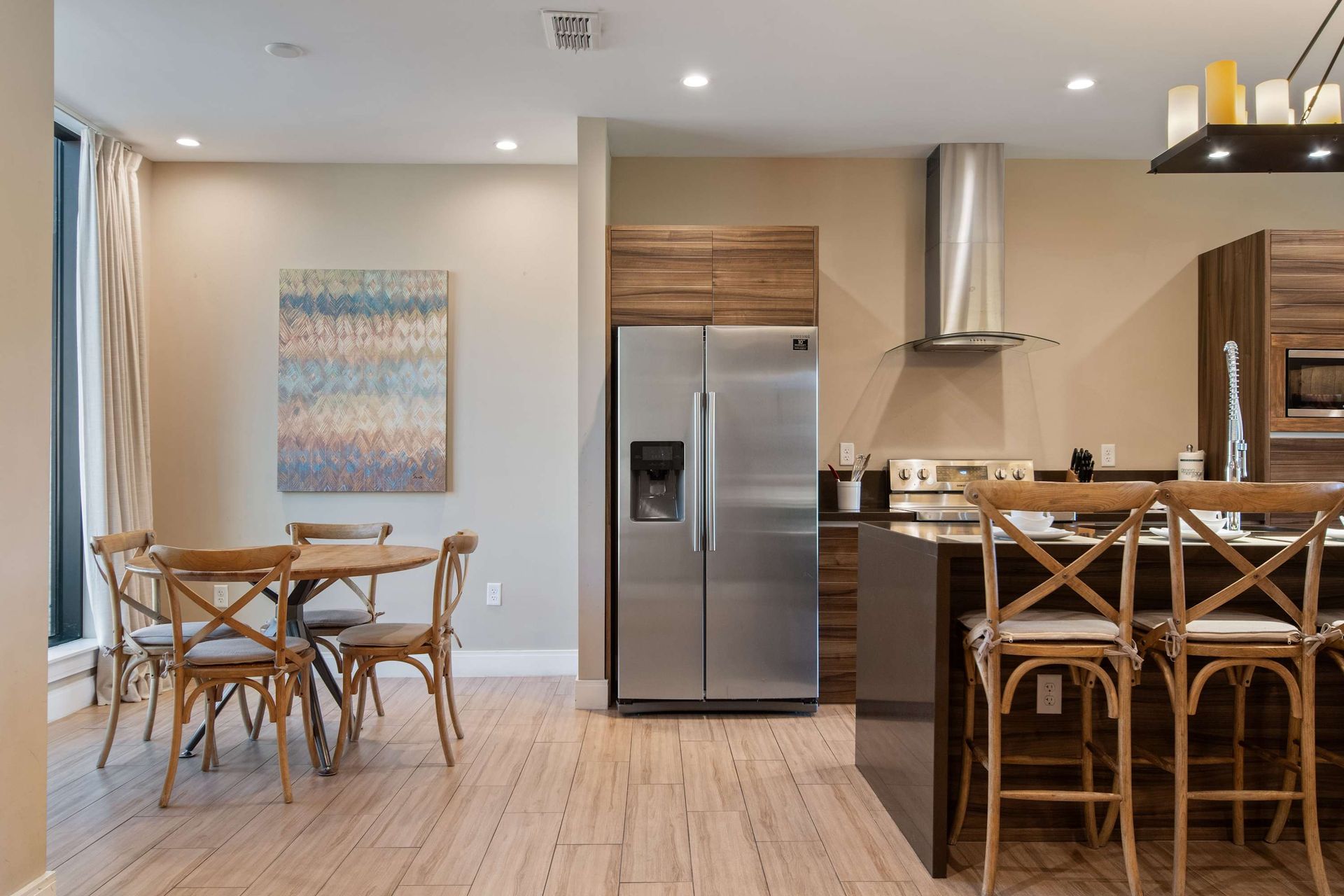 Modern kitchen with stainless appliances, breakfast nook, and spacious island seating.
