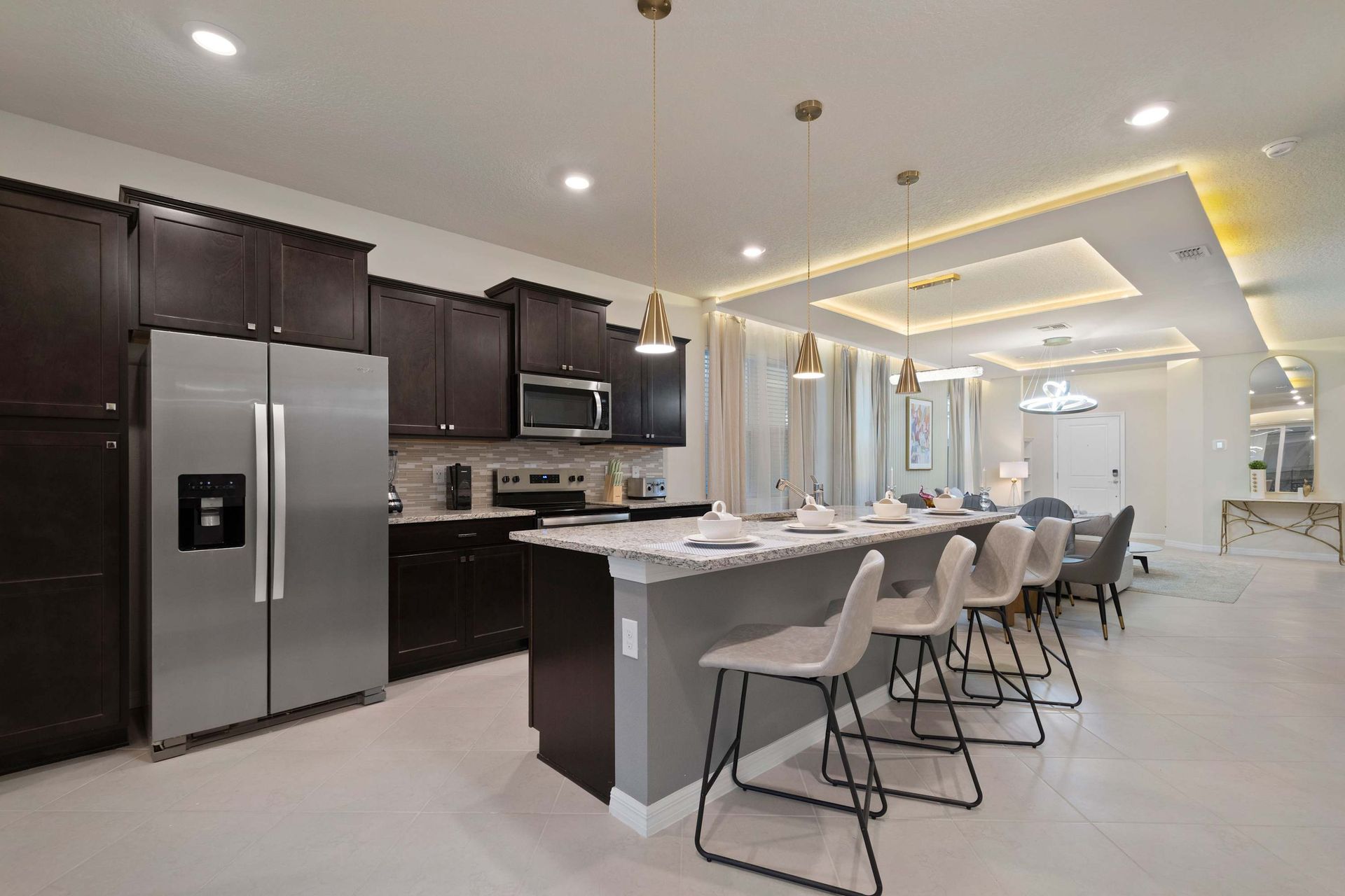 Spacious modern kitchen with large island, sleek finishes, and open-concept flow.

