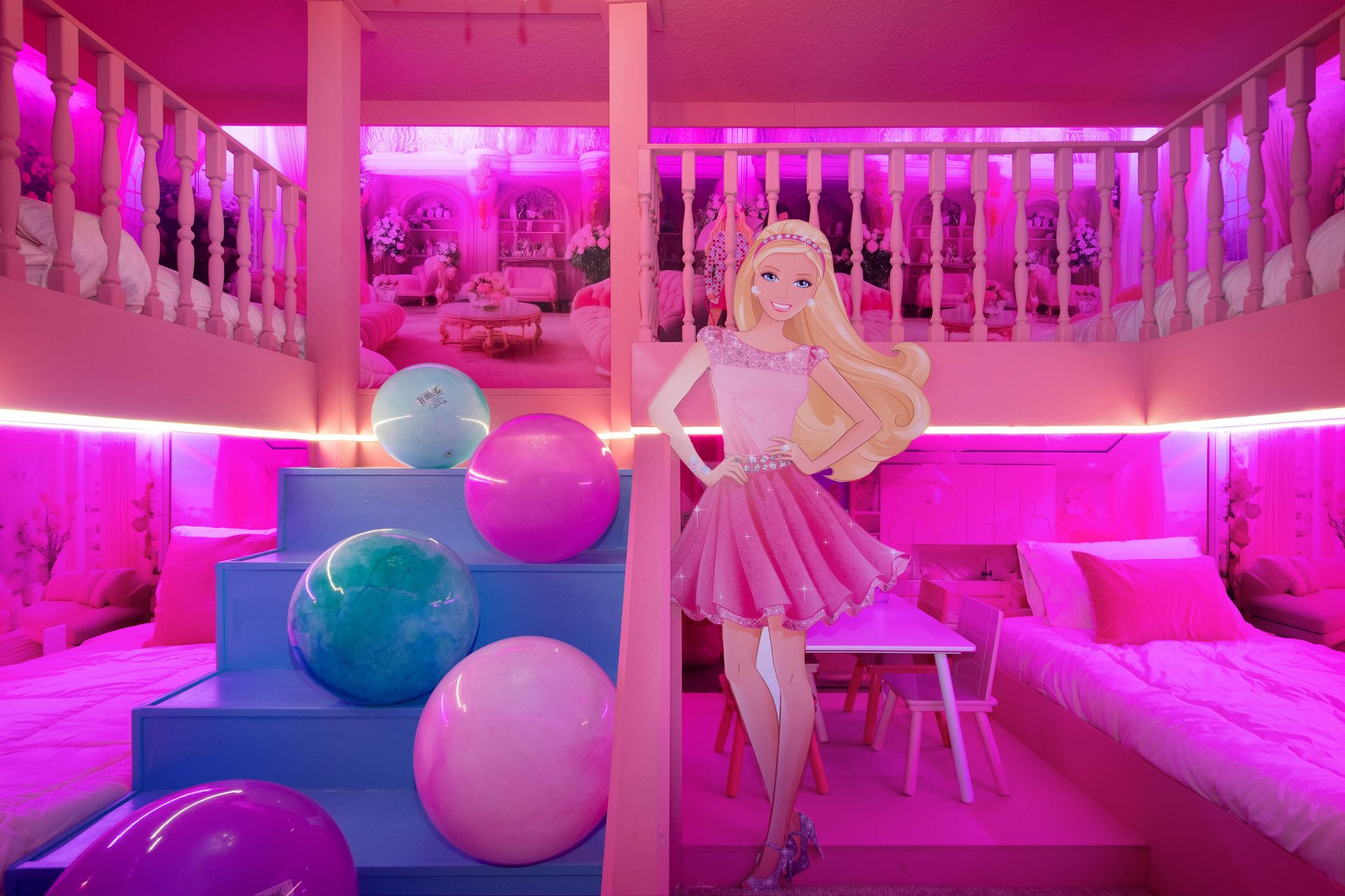 Barbie-themed dream room with pink décor, loft beds, and playful glam touches.

