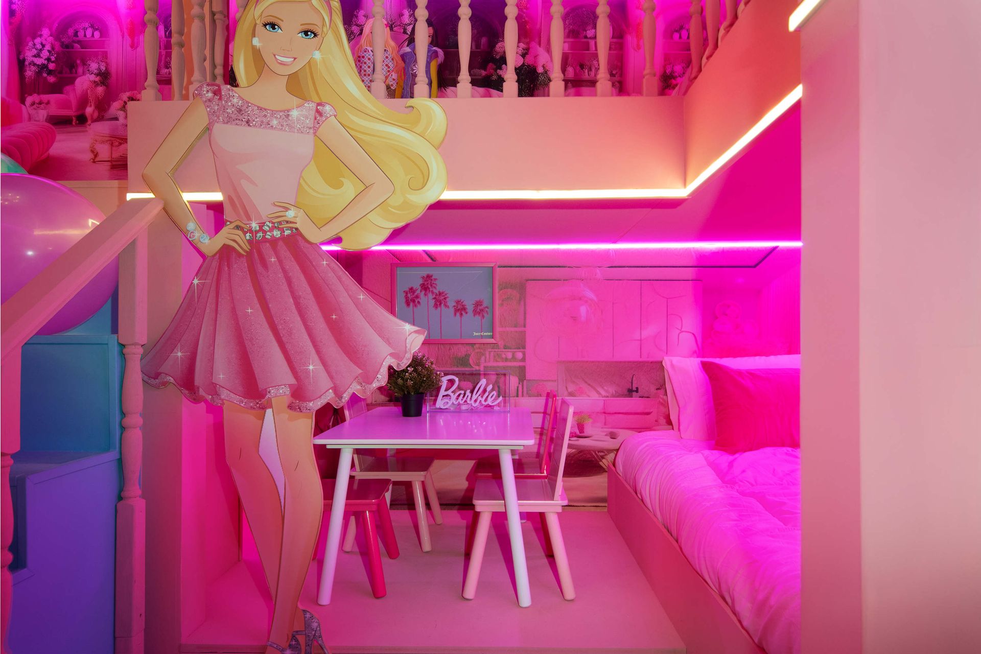 All-pink Barbie dream room with cozy beds, play table, and glowing neon lights.
