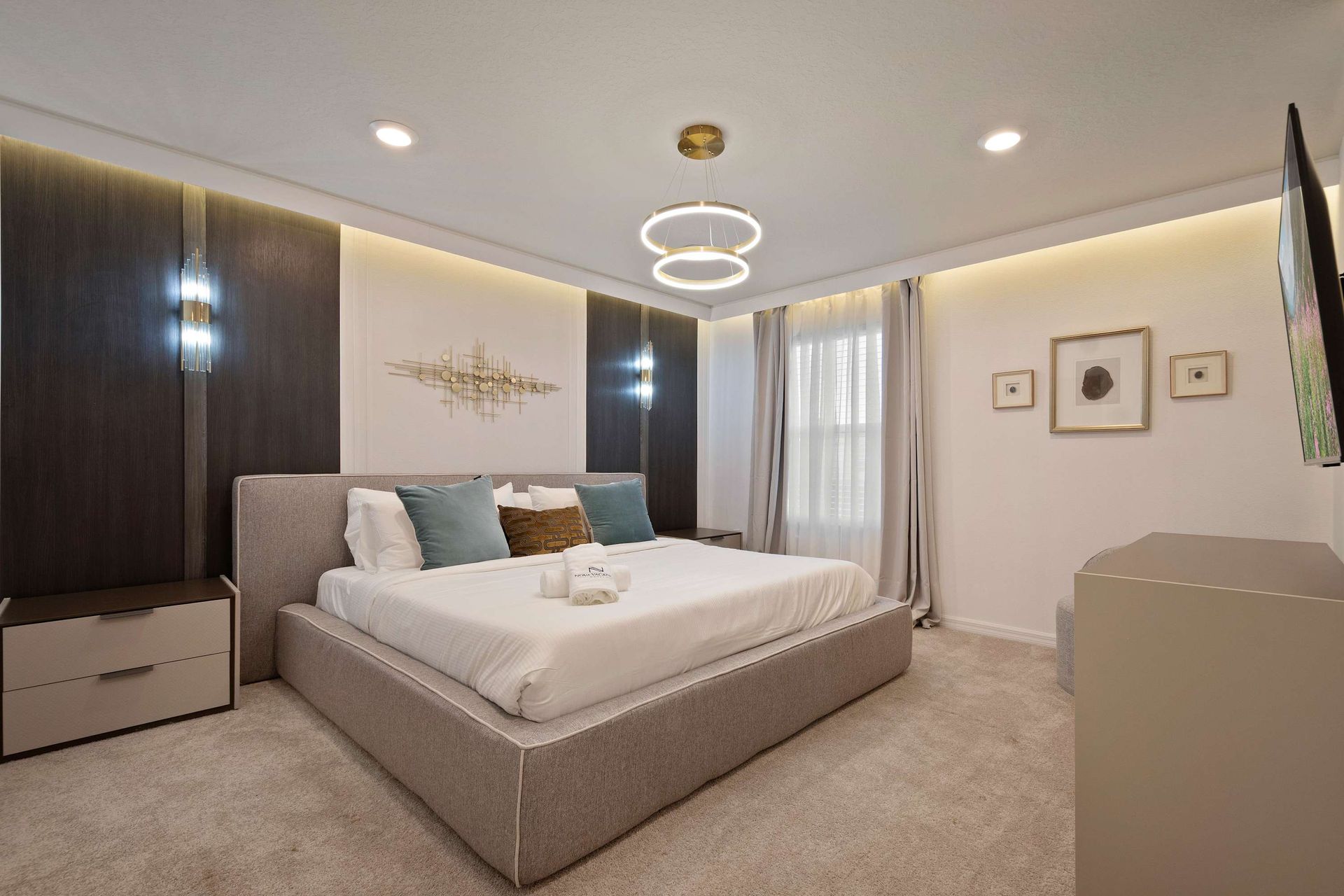 Modern luxury bedroom with king bed, ambient lighting, and elegant décor touches.
