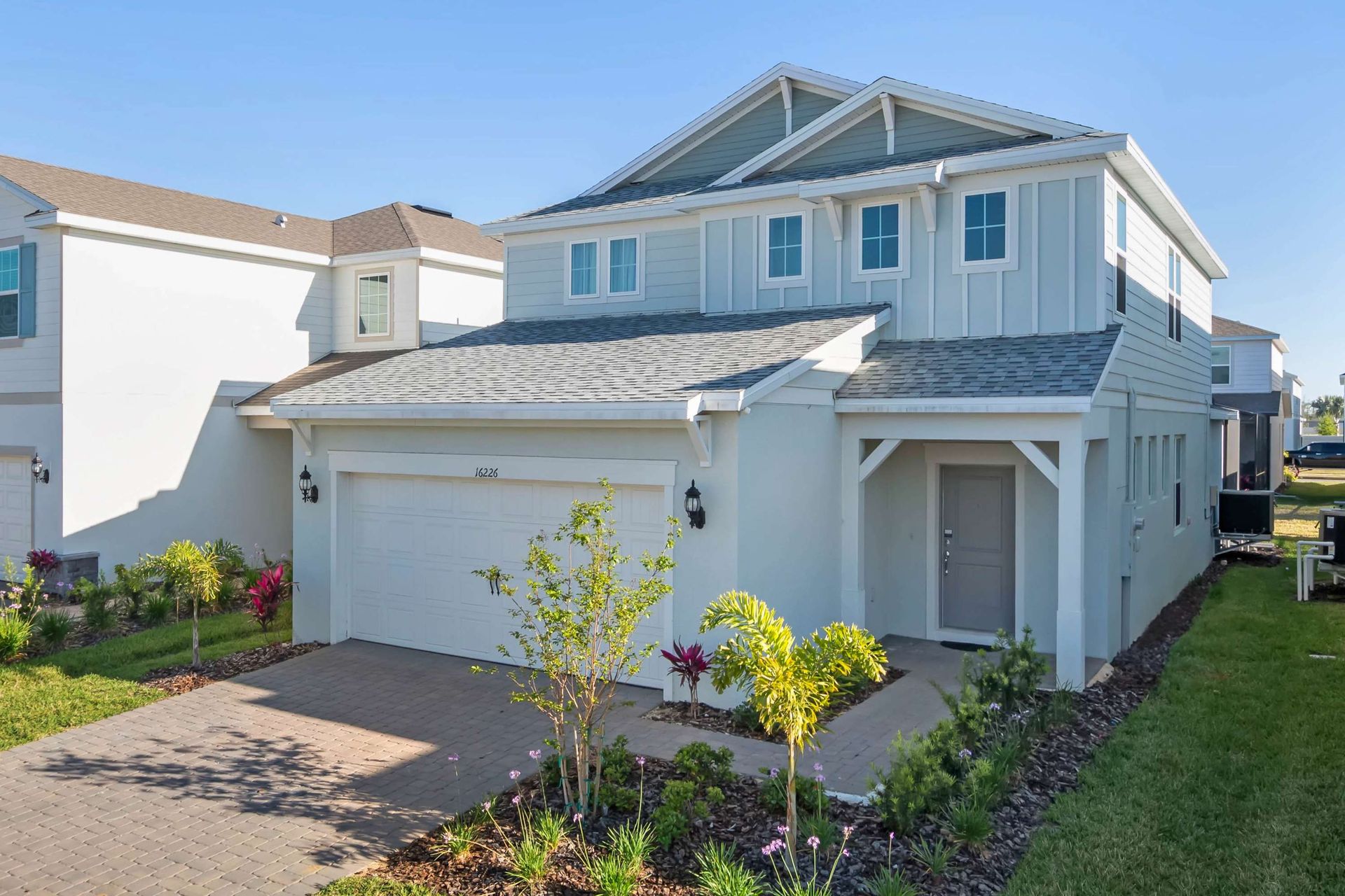 Modern 2-story vacation home with private pool, garage, and beautifully landscaped yard.
