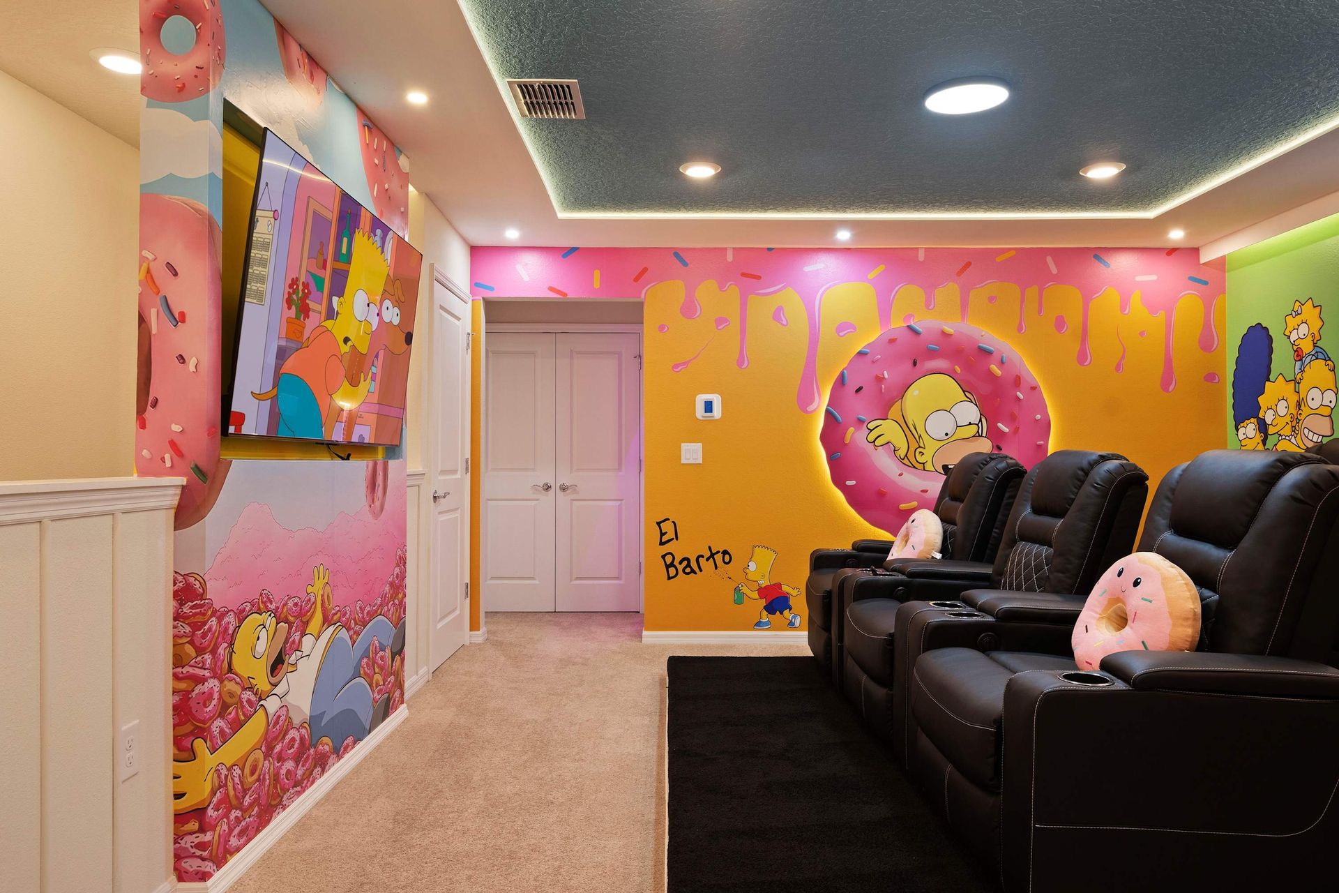 Whimsical Simpsons-themed home theater with cozy recliners and vibrant decor.
