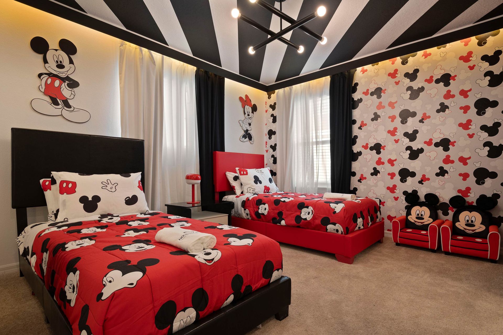 Mickey Mouse-themed bedroom with bold decor, cozy beds, and magical charm.
