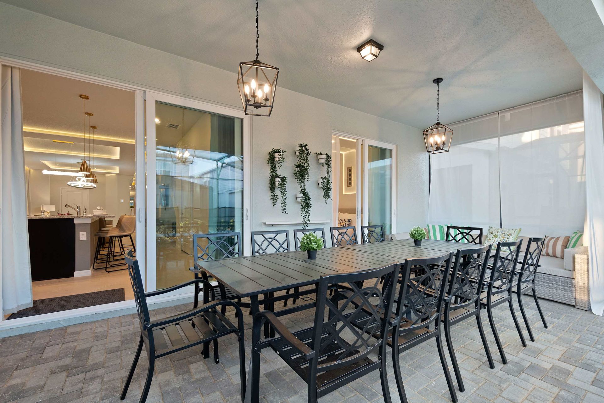 Covered patio with elegant lighting, dining for 12, and direct indoor-outdoor flow.
