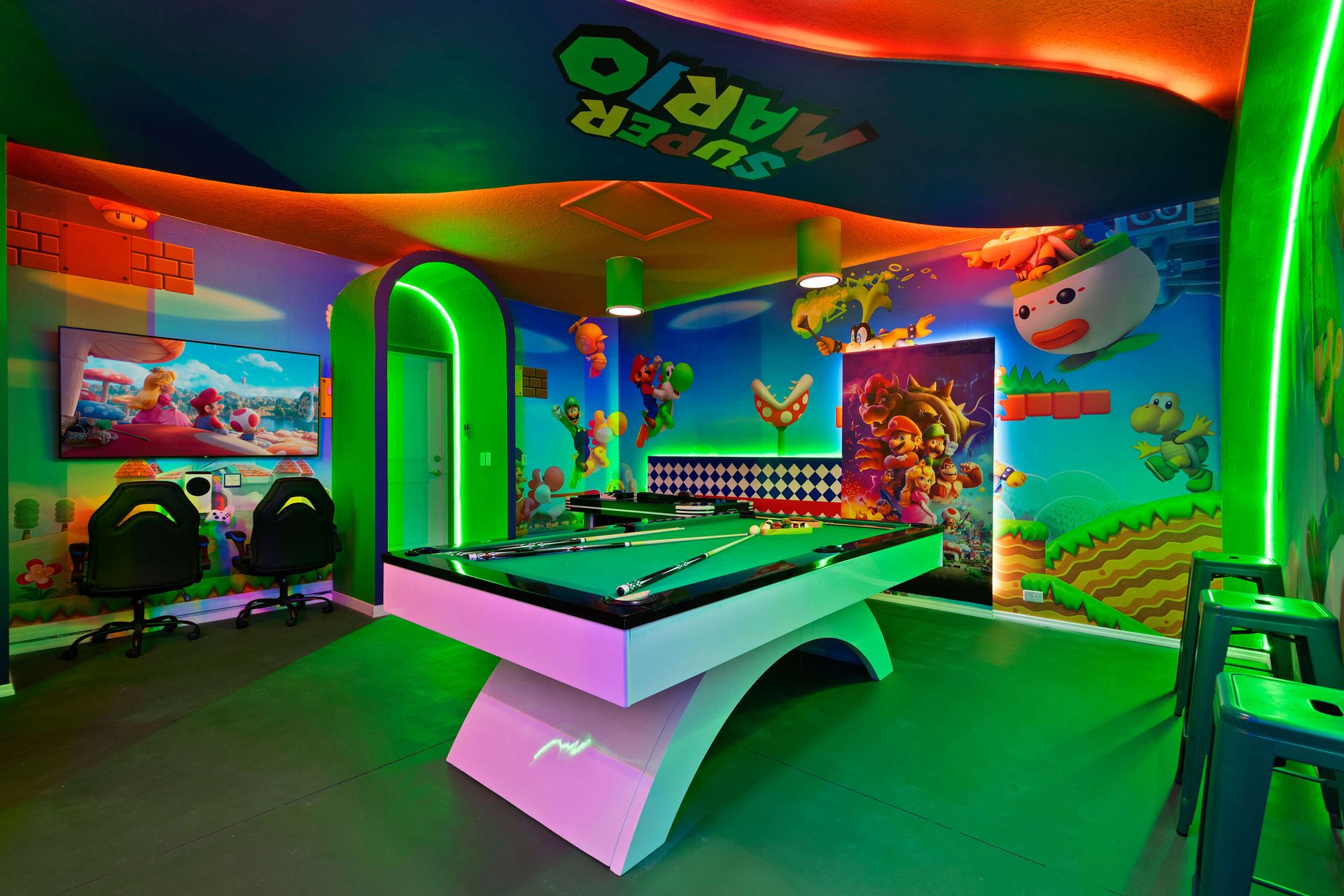 Immersive Super Mario arcade room with pool table, neon lights, and wall art.
