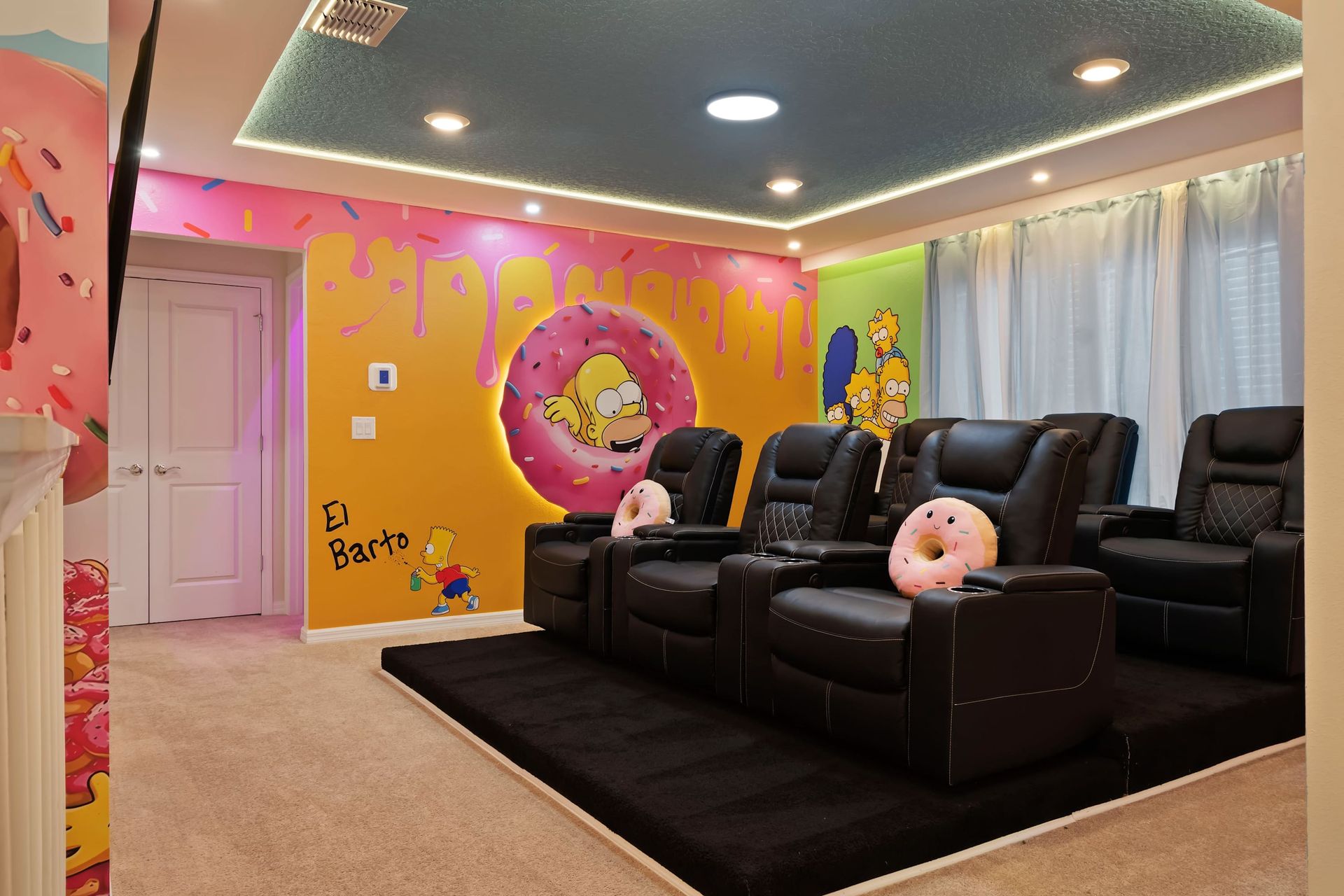 Simpsons-themed movie room with comfy recliners, playful murals, and cozy vibes.
