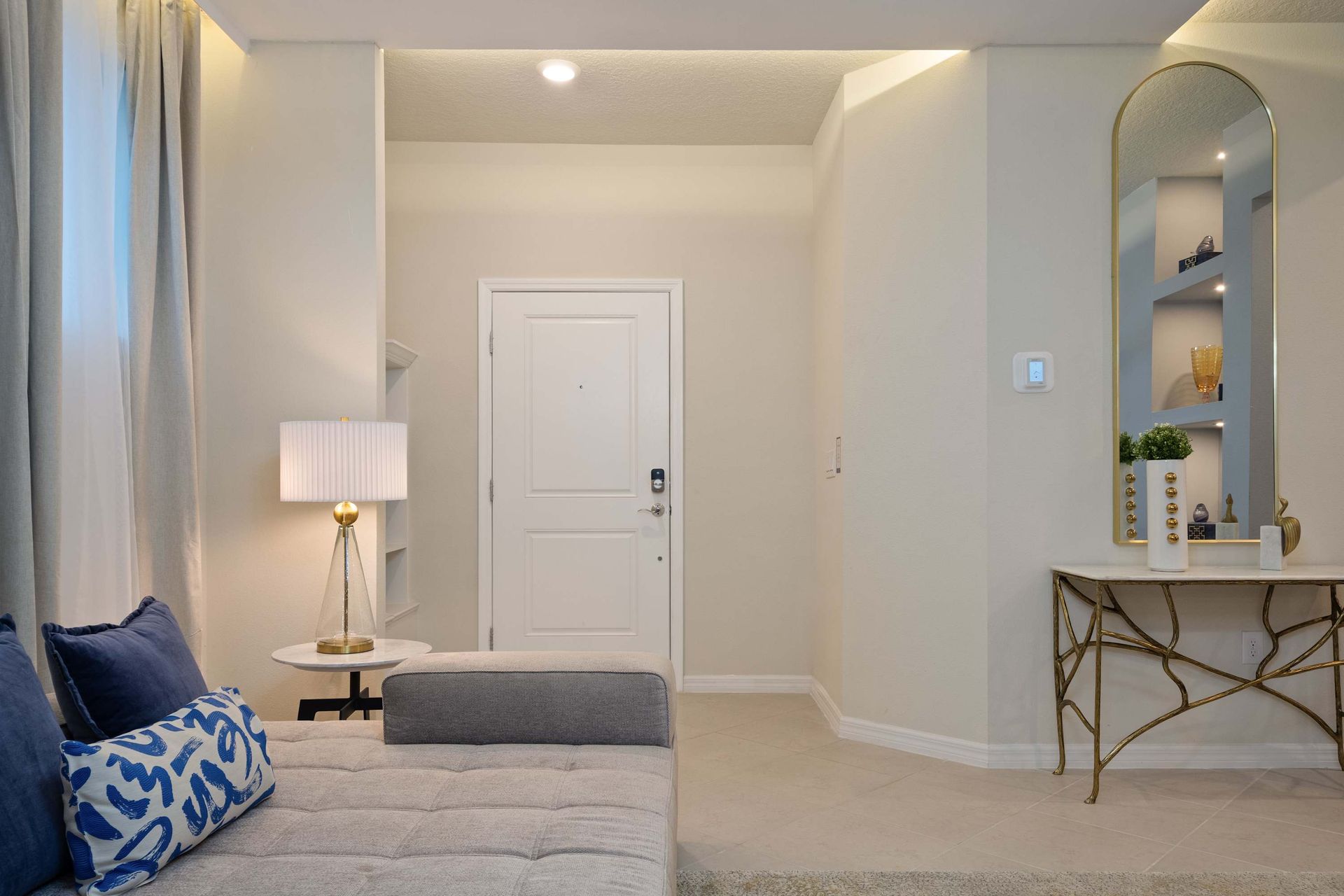 Chic entryway with elegant console, modern lighting, and a cozy, welcoming vibe.
