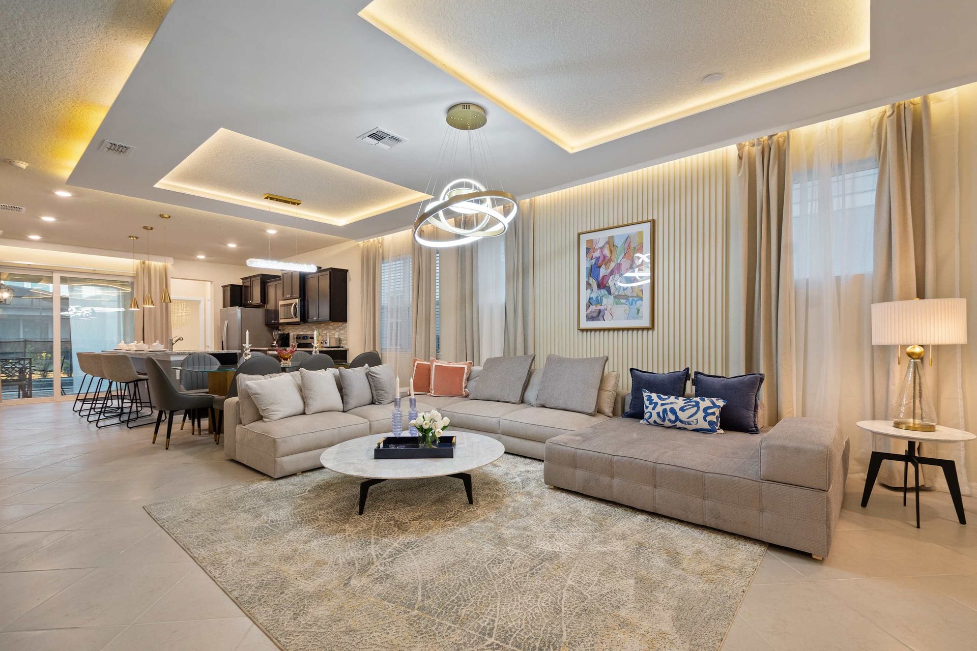 Spacious open-concept living area with modern lighting, luxe seating, and style.

