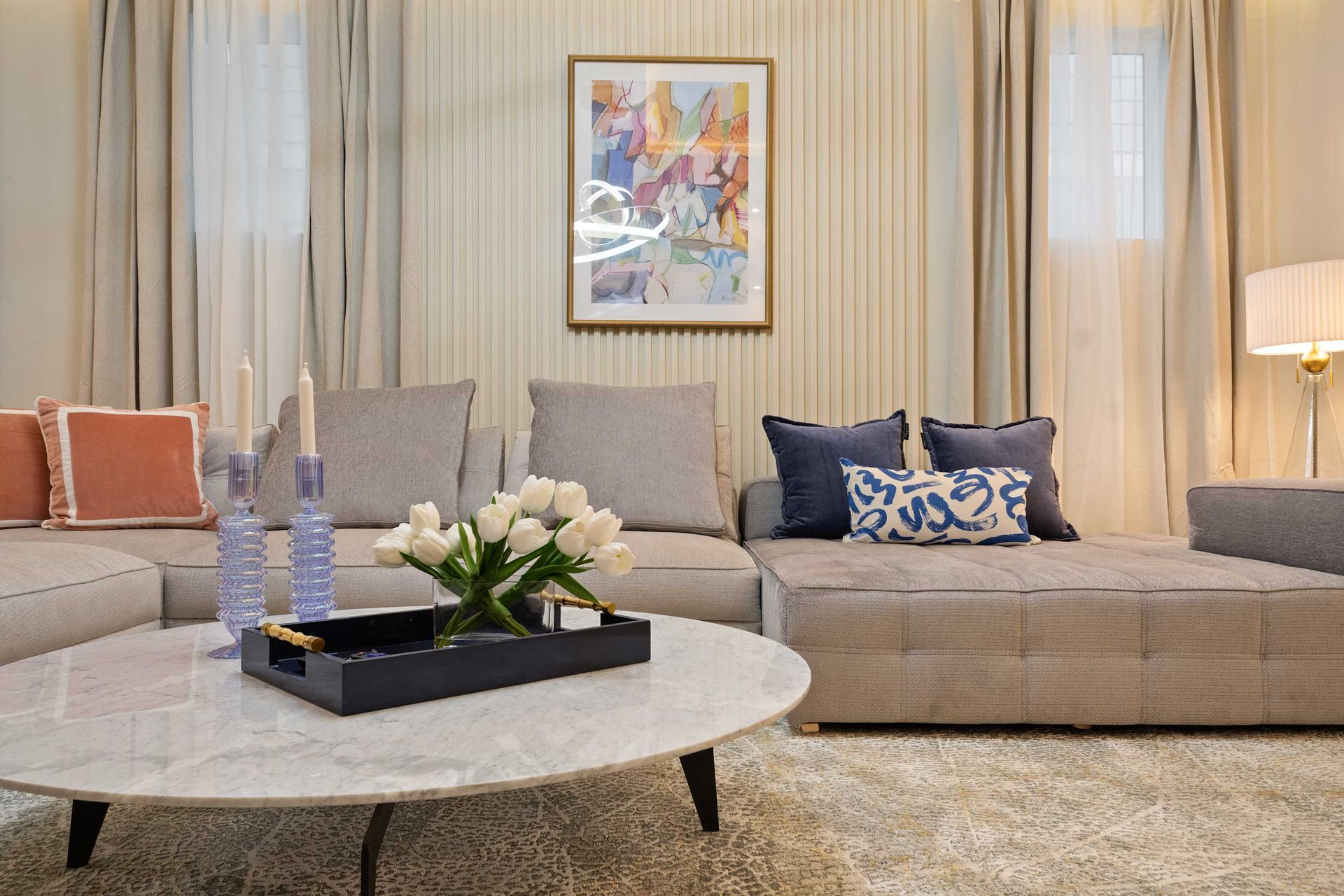 Elegant lounge with plush seating, chic decor, and a stylish marble coffee table.
