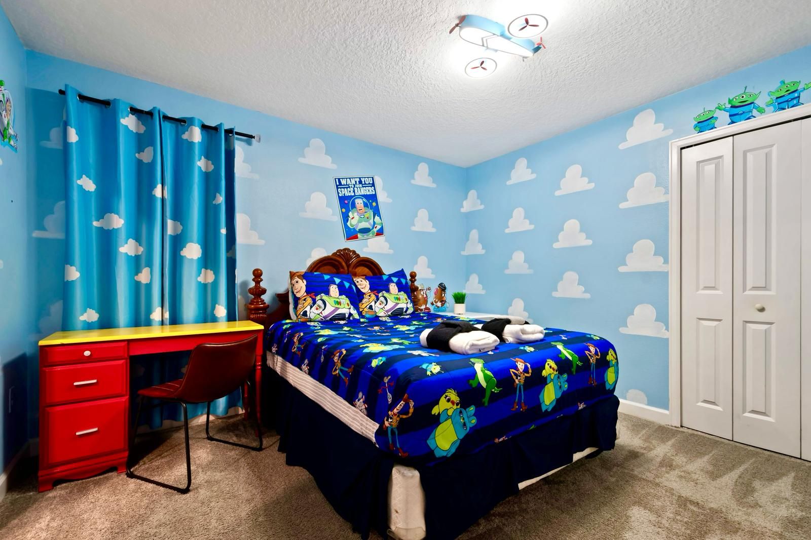 Blast off to fun in this Toy Story-inspired bedroom with playful decor and cozy vibes!