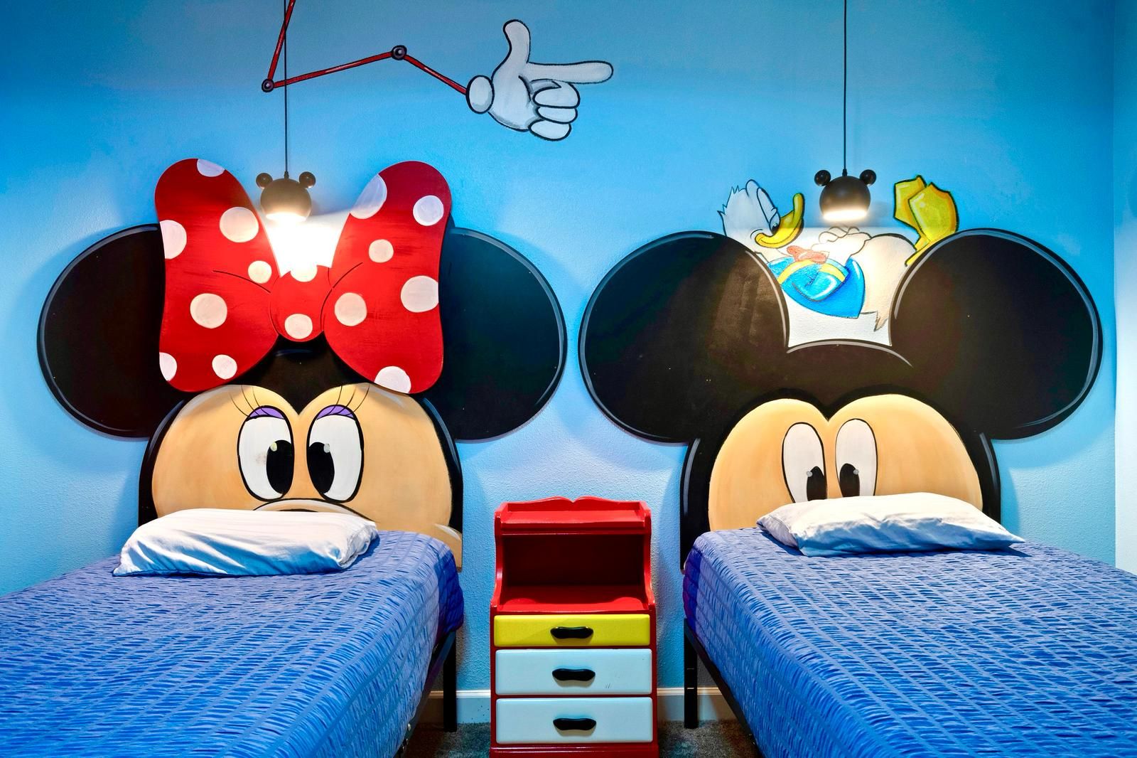 Whimsical twin beds bring Disney magic to life in this Mickey and Minnie room!