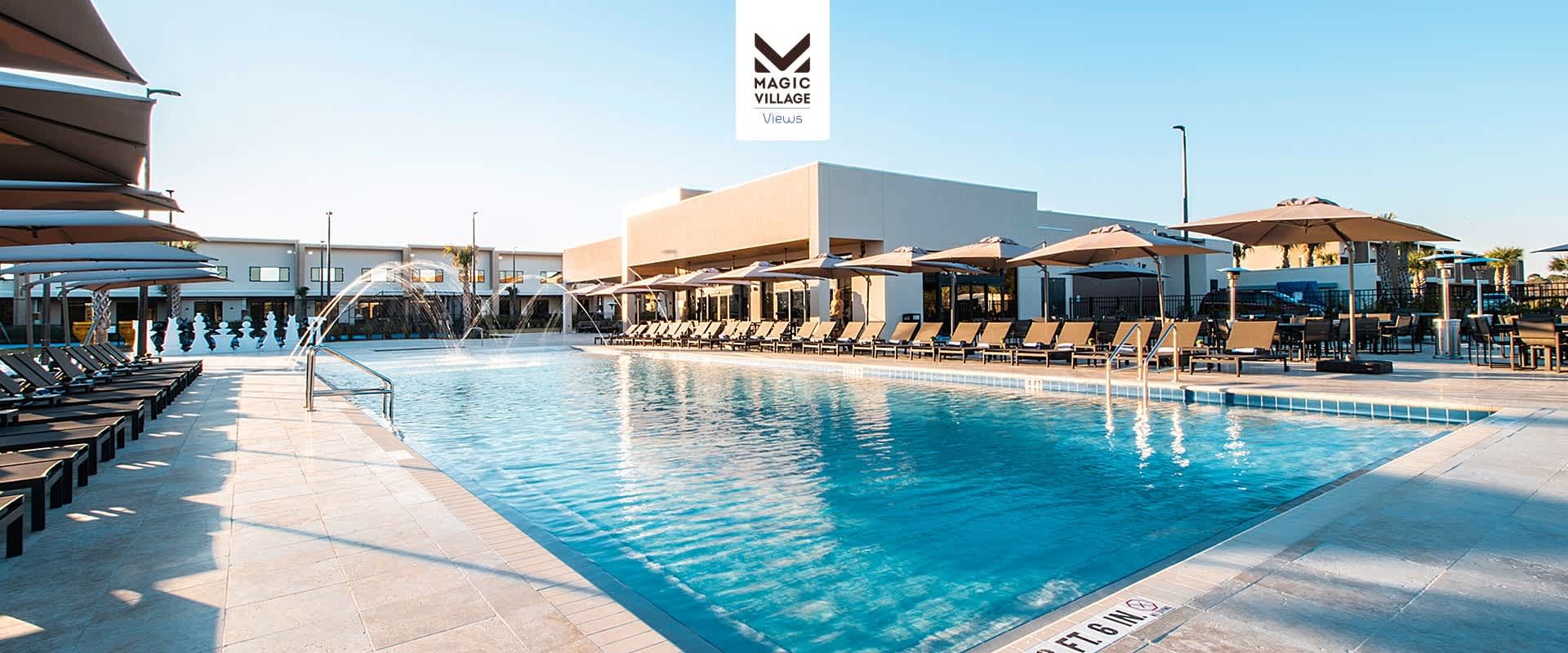 Resort-style pool with plenty of lounge chairs, umbrellas, and refreshing water jets.
