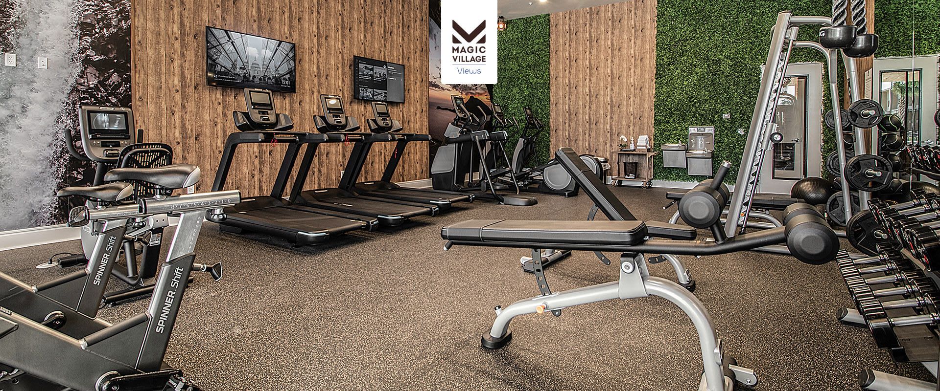 Modern fitness center with cardio machines, free weights, and stylish decor
