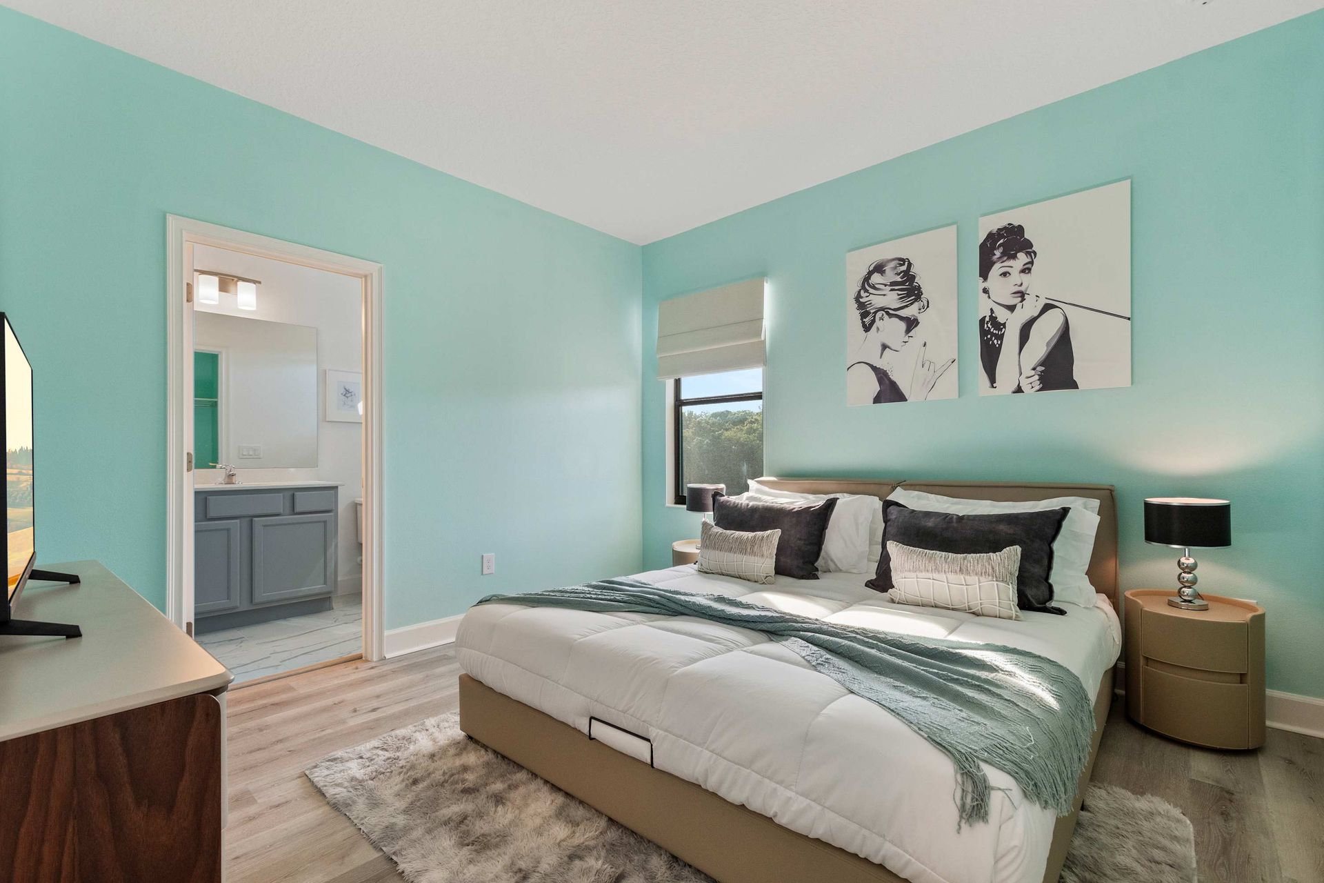 Chic bedroom with retro glam touches, mint walls, plush bedding, and en-suite bath
