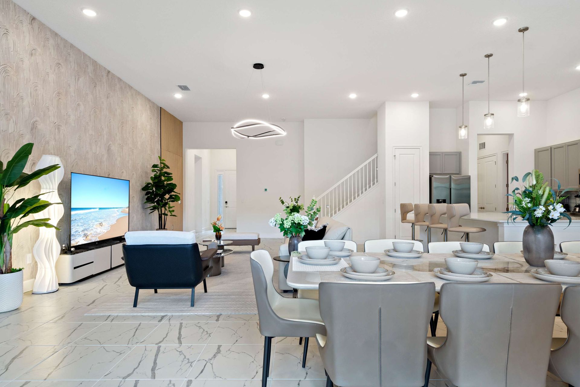 Modern open living with elegant dining, stylish seating, and fully equipped kitchen
