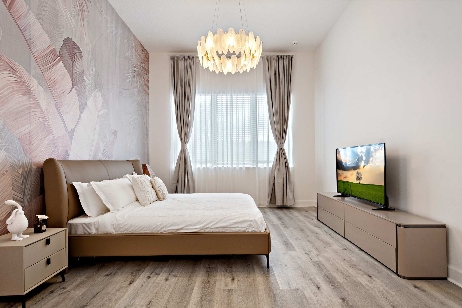Elegant bedroom with statement wall, modern furnishings, and large smart TV
