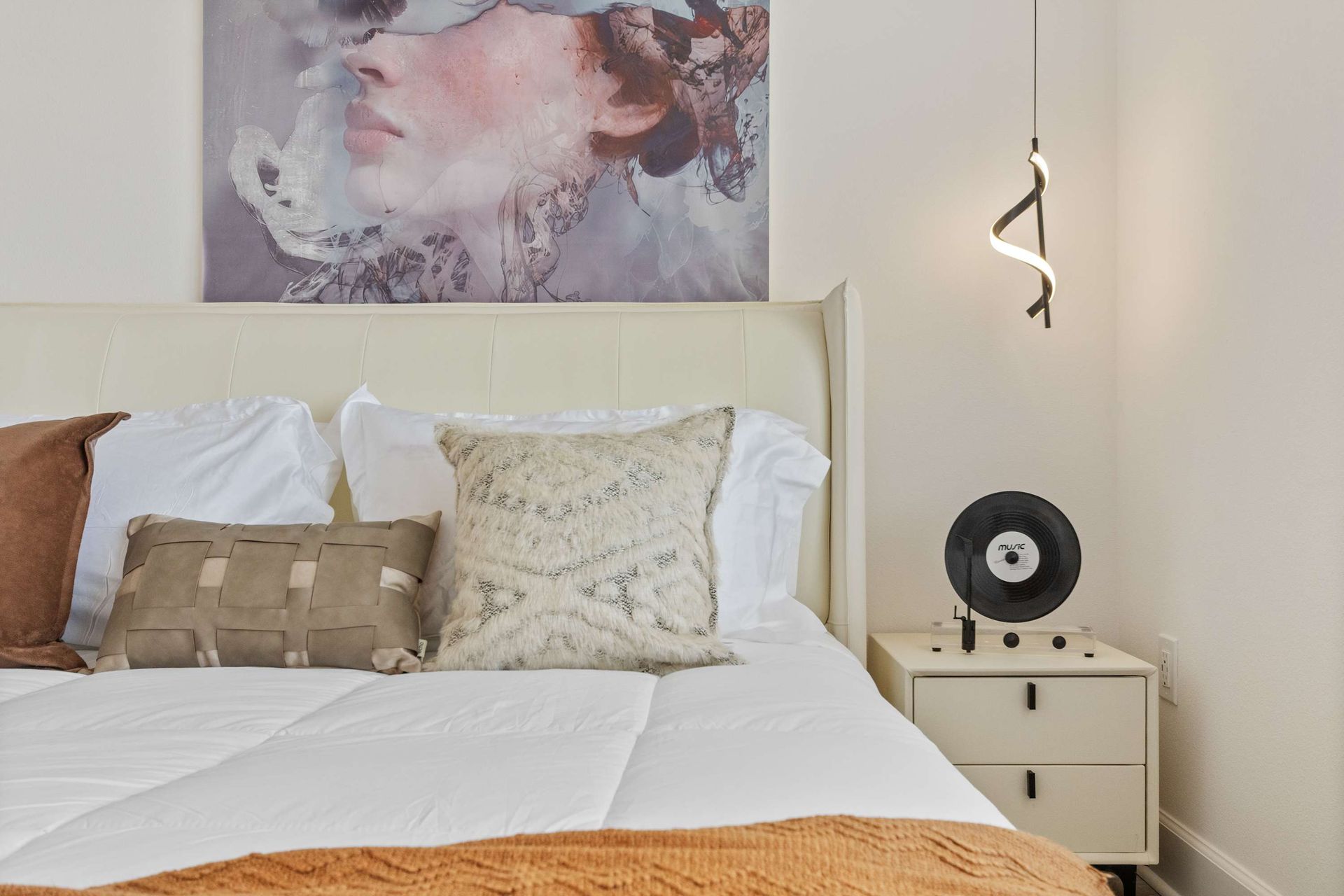 Bright corner bedroom with modern style, cozy king bed, and serene outdoor views
