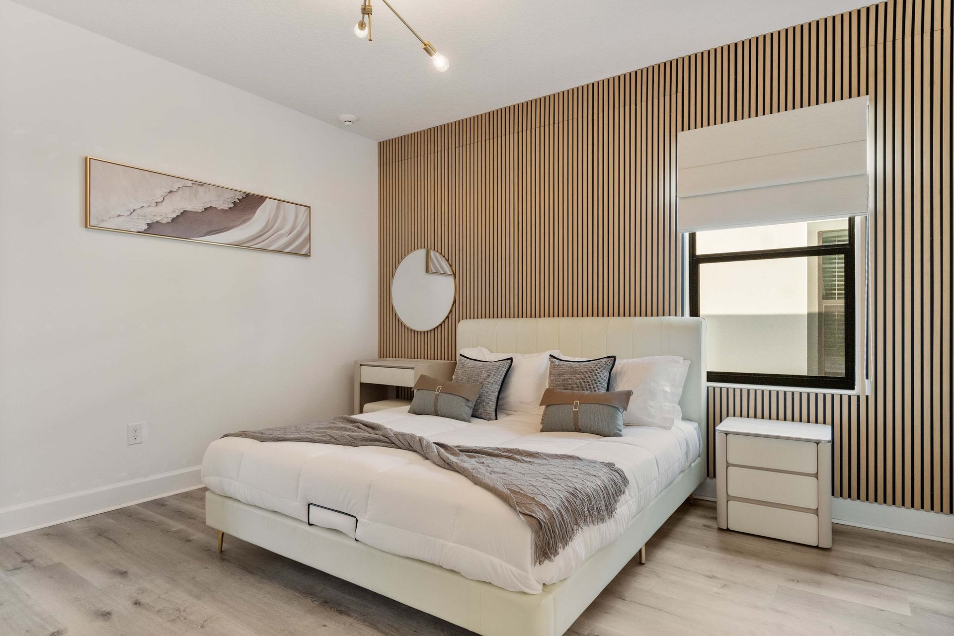 Serene modern bedroom with wood accent wall, cozy king bed, and natural light
