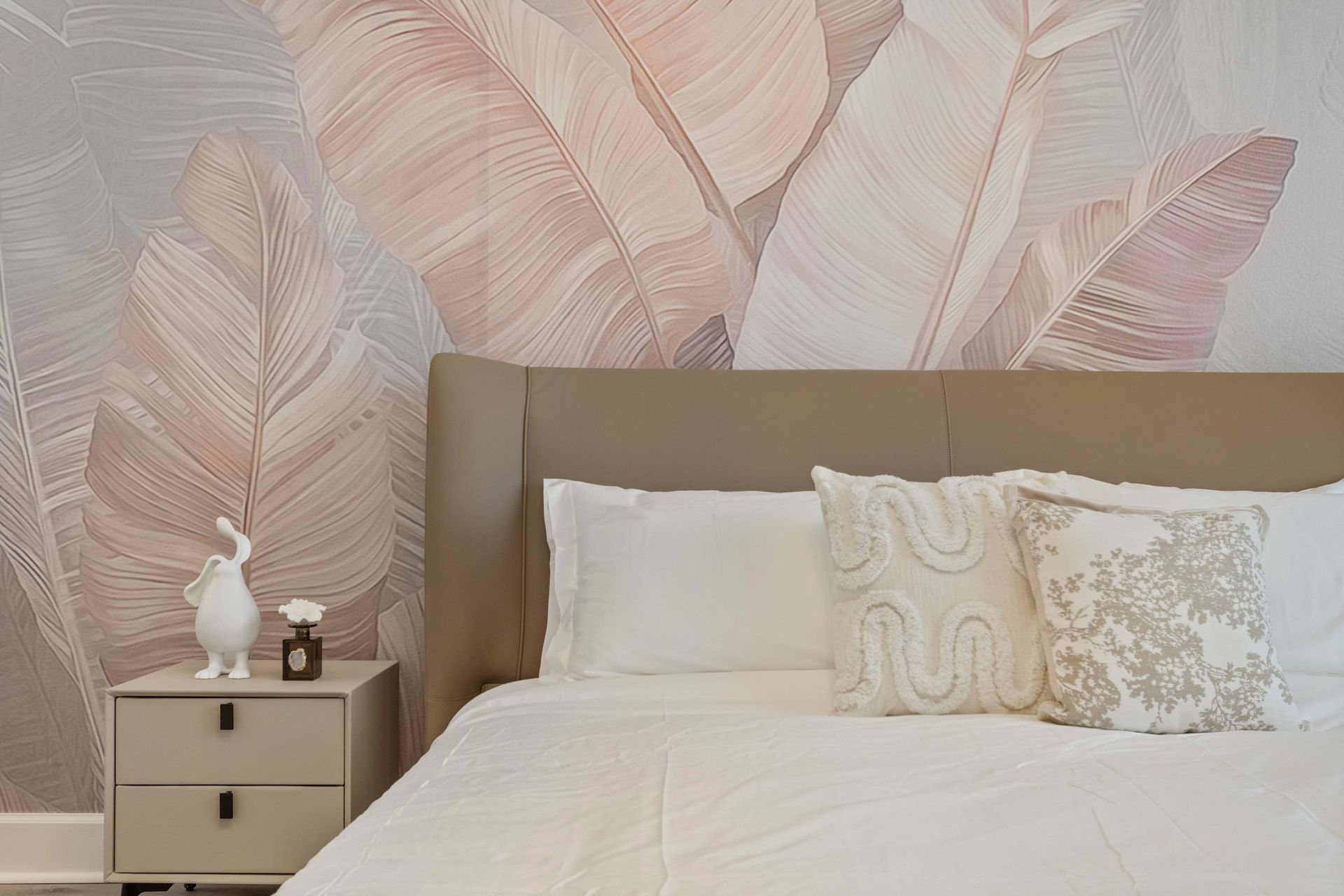 Elegant bedroom with statement wall, modern furnishings, and large smart TV
