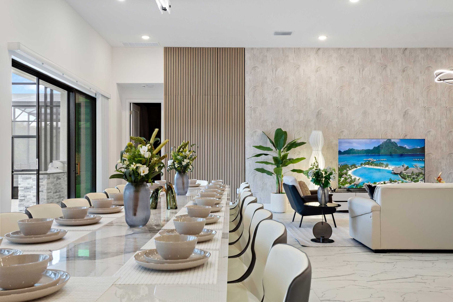 Elegant open-concept layout with long dining table, sleek décor, and cozy lounge area
