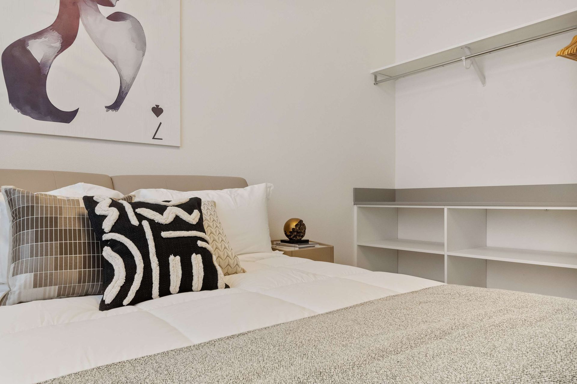 Stylish bedroom with chic décor, cozy king bed, and large TV for relaxing nights
