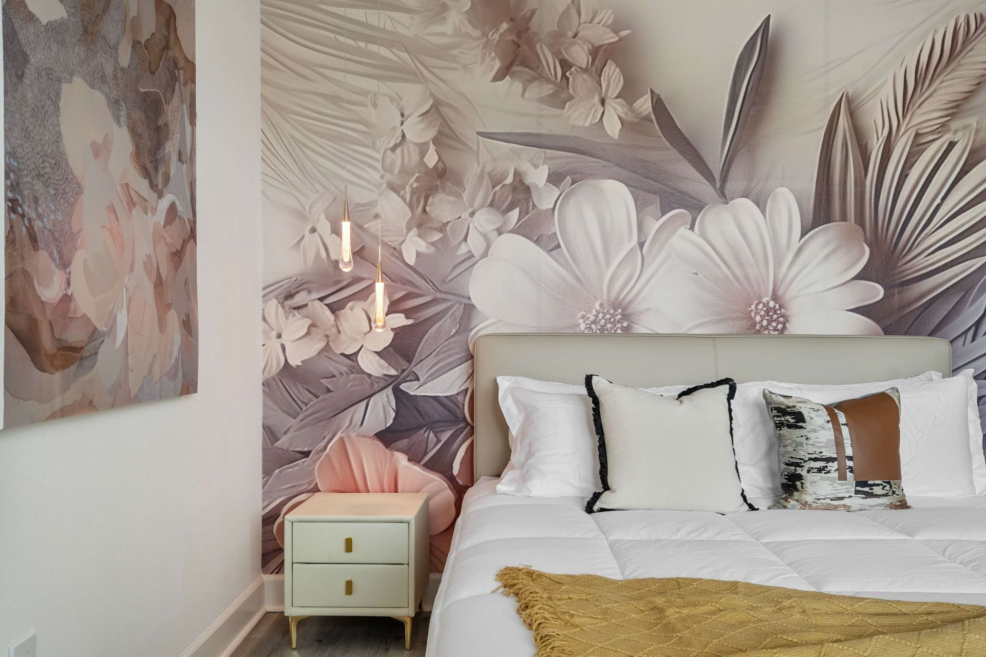 Tropical-inspired bedroom with bold accent wall, cozy bed, and modern lighting
