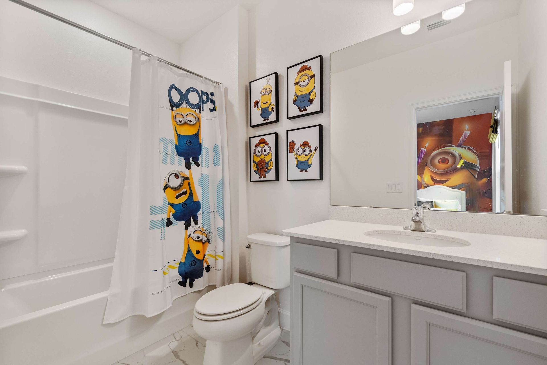 Fun Minion-themed bathroom with playful artwork, bright accents, and full tub setup
