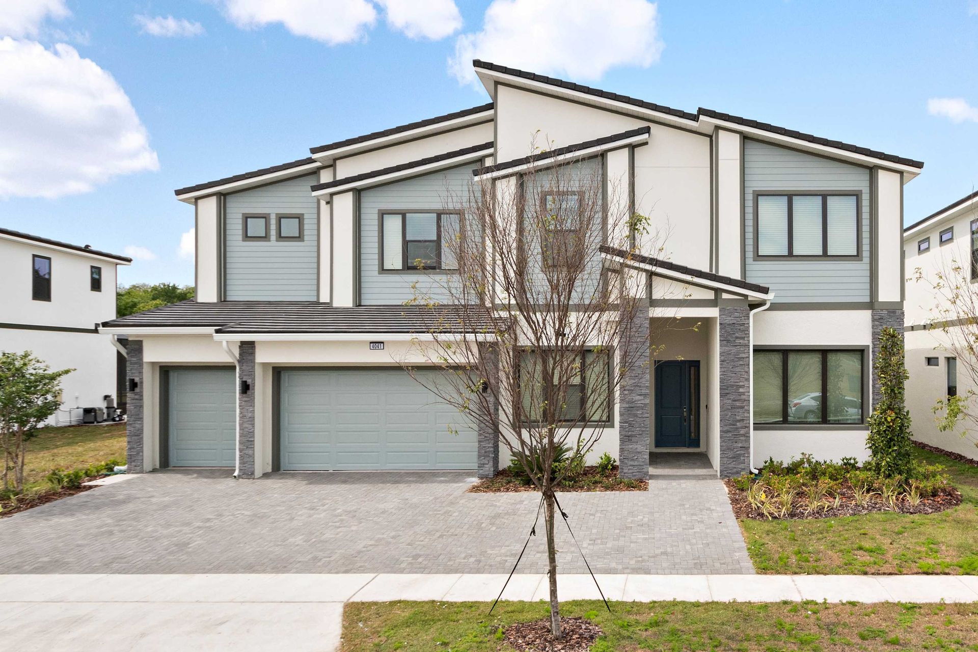 Modern 9-bedroom villa with spacious layout, 3-car garage, and upscale curb appeal
