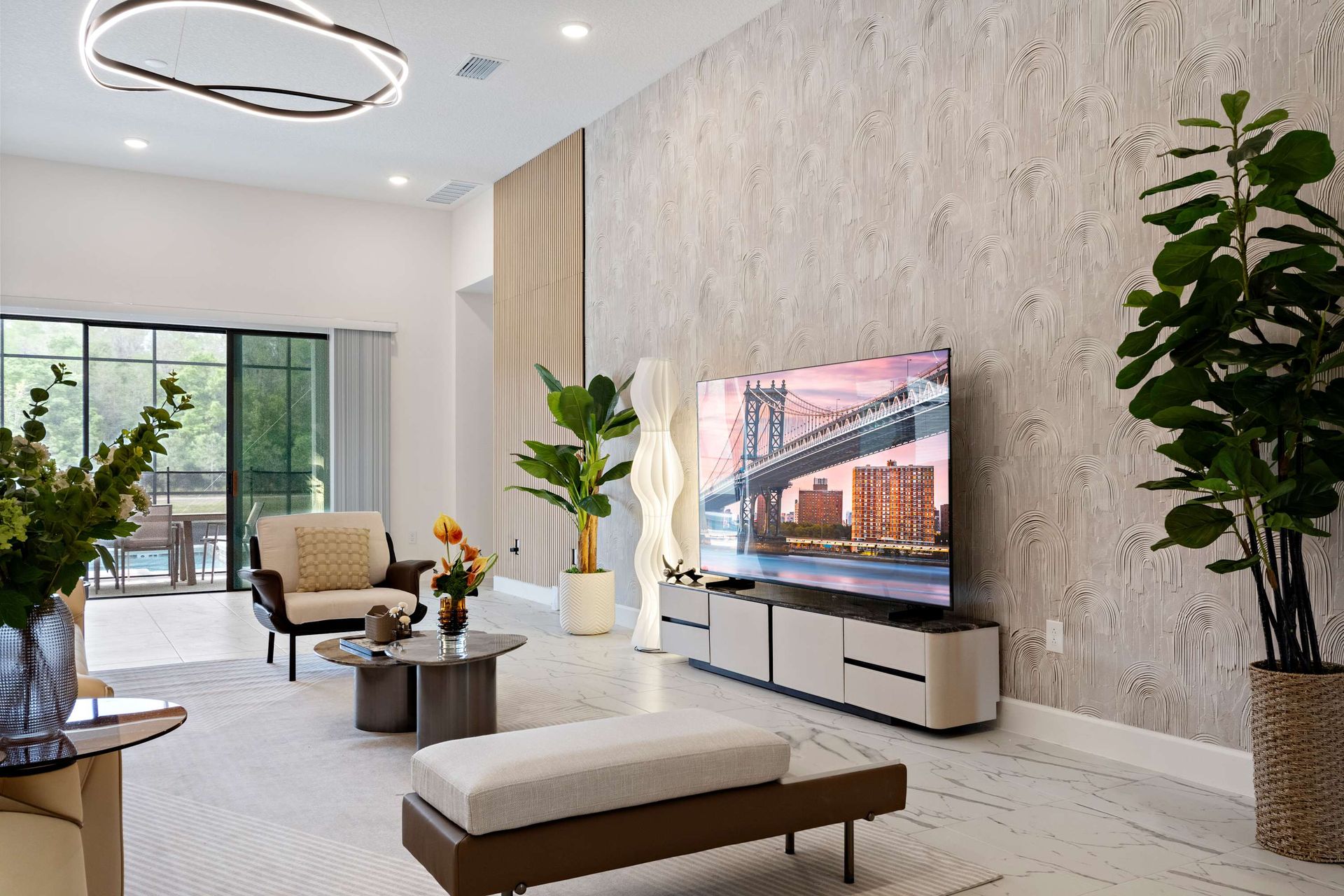 Stylish open living space with smart TV, modern décor, and indoor-outdoor flow
