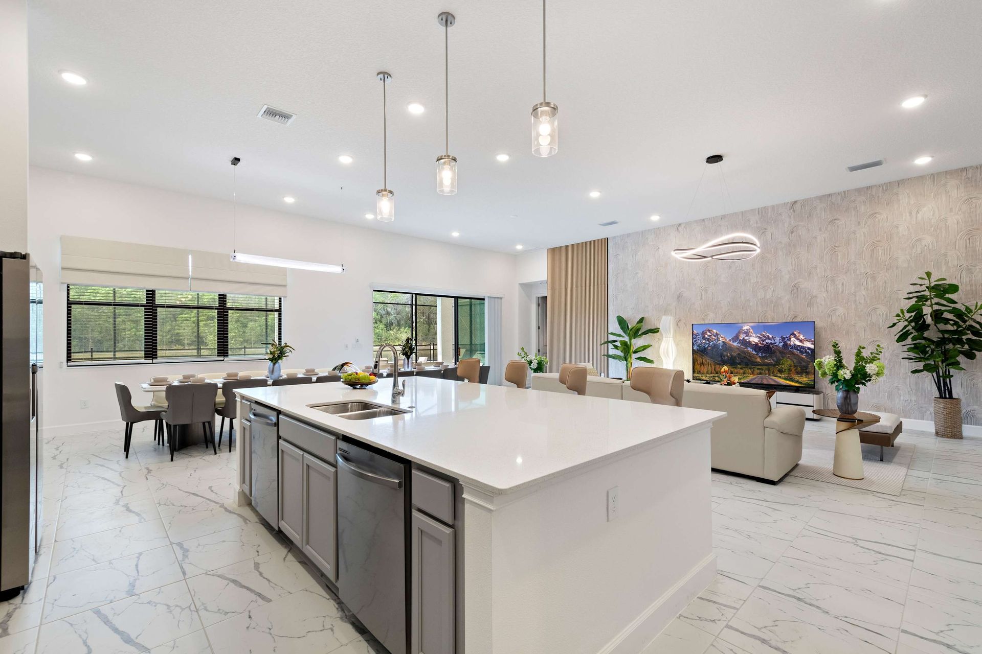 Spacious open-concept kitchen and living area with island seating and sleek design
