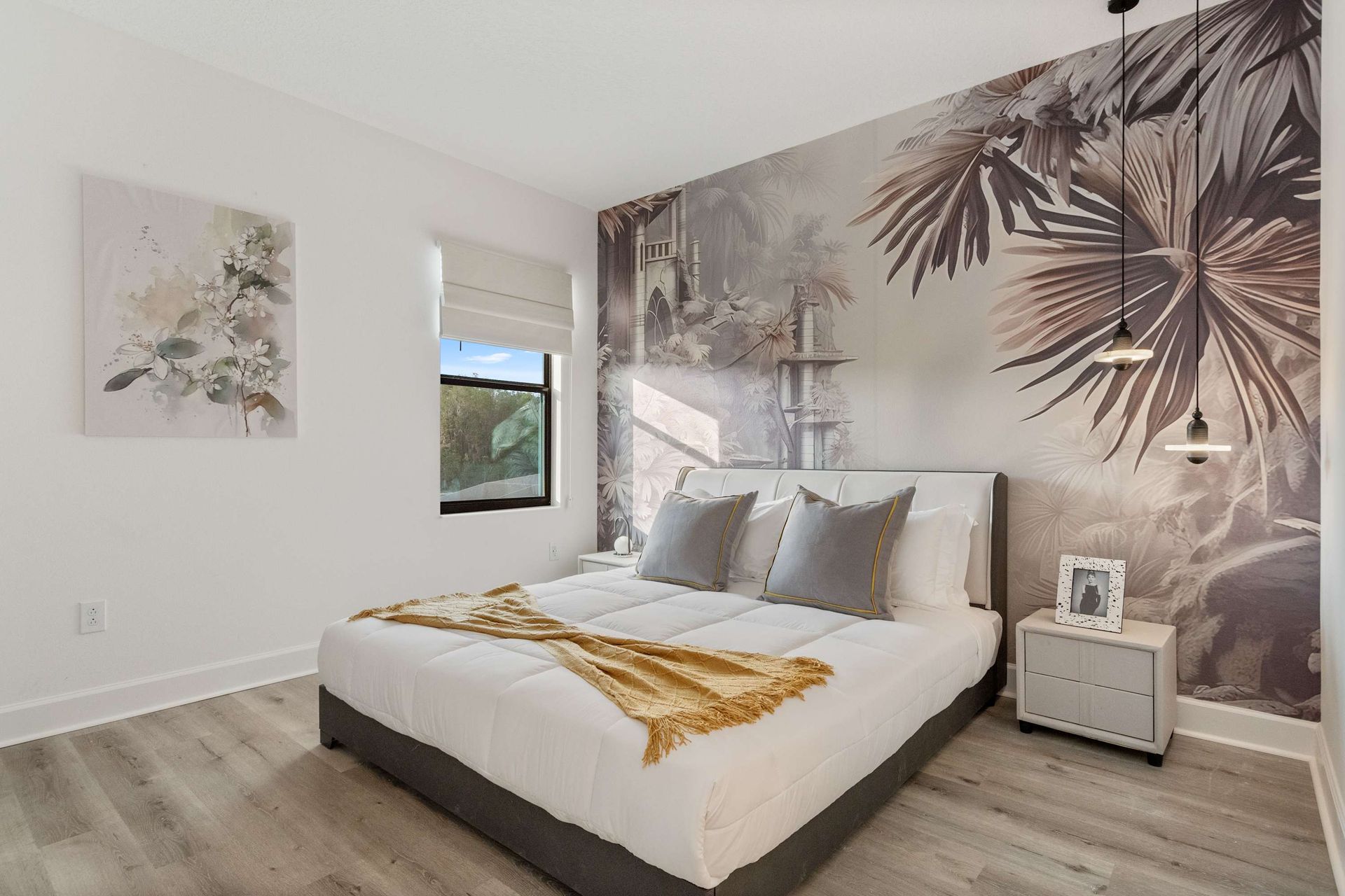 Tropical-inspired bedroom with bold accent wall, cozy bed, and modern lighting
