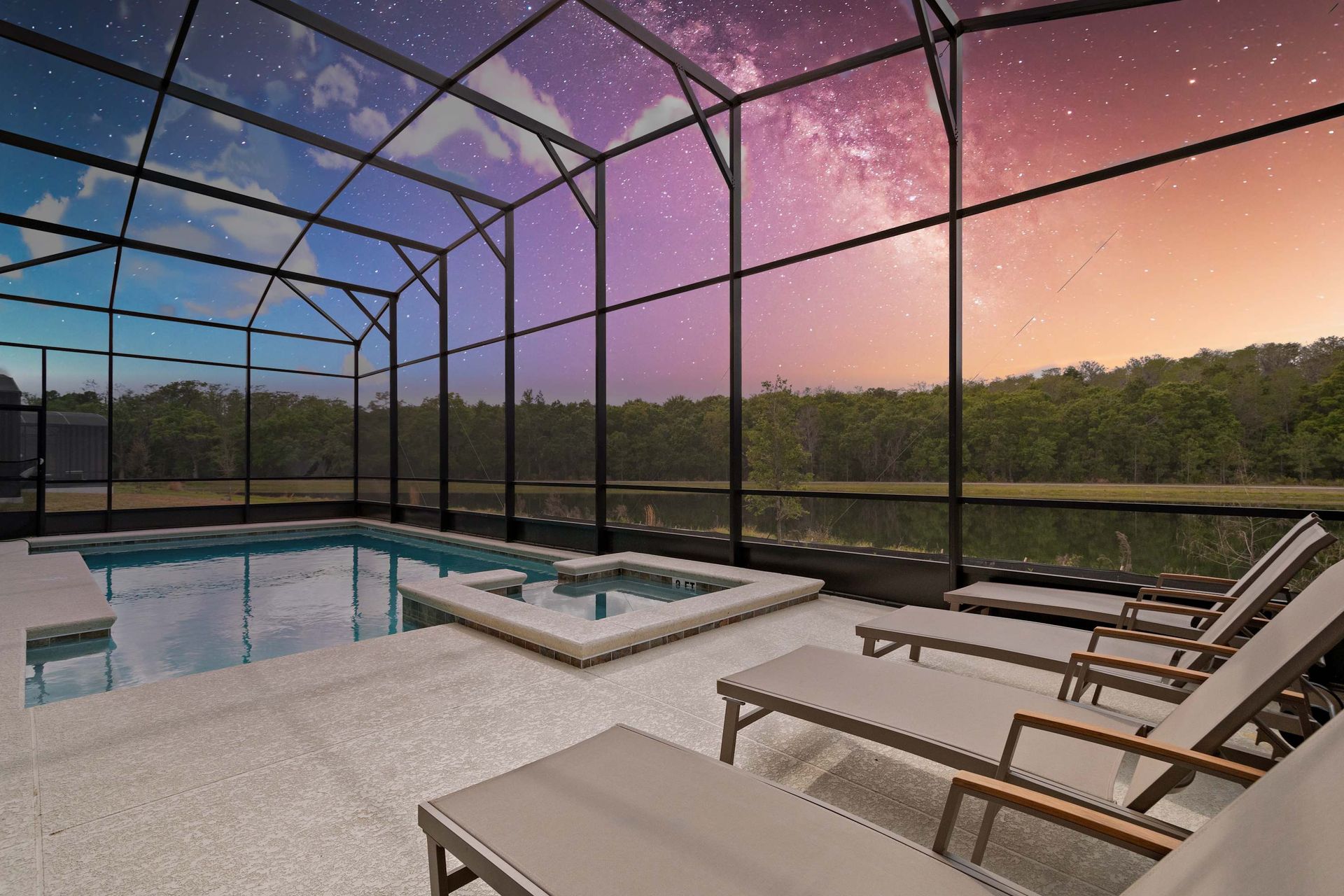 Tranquil screened-in pool and spa with loungers, lake views, and stunning night sky
