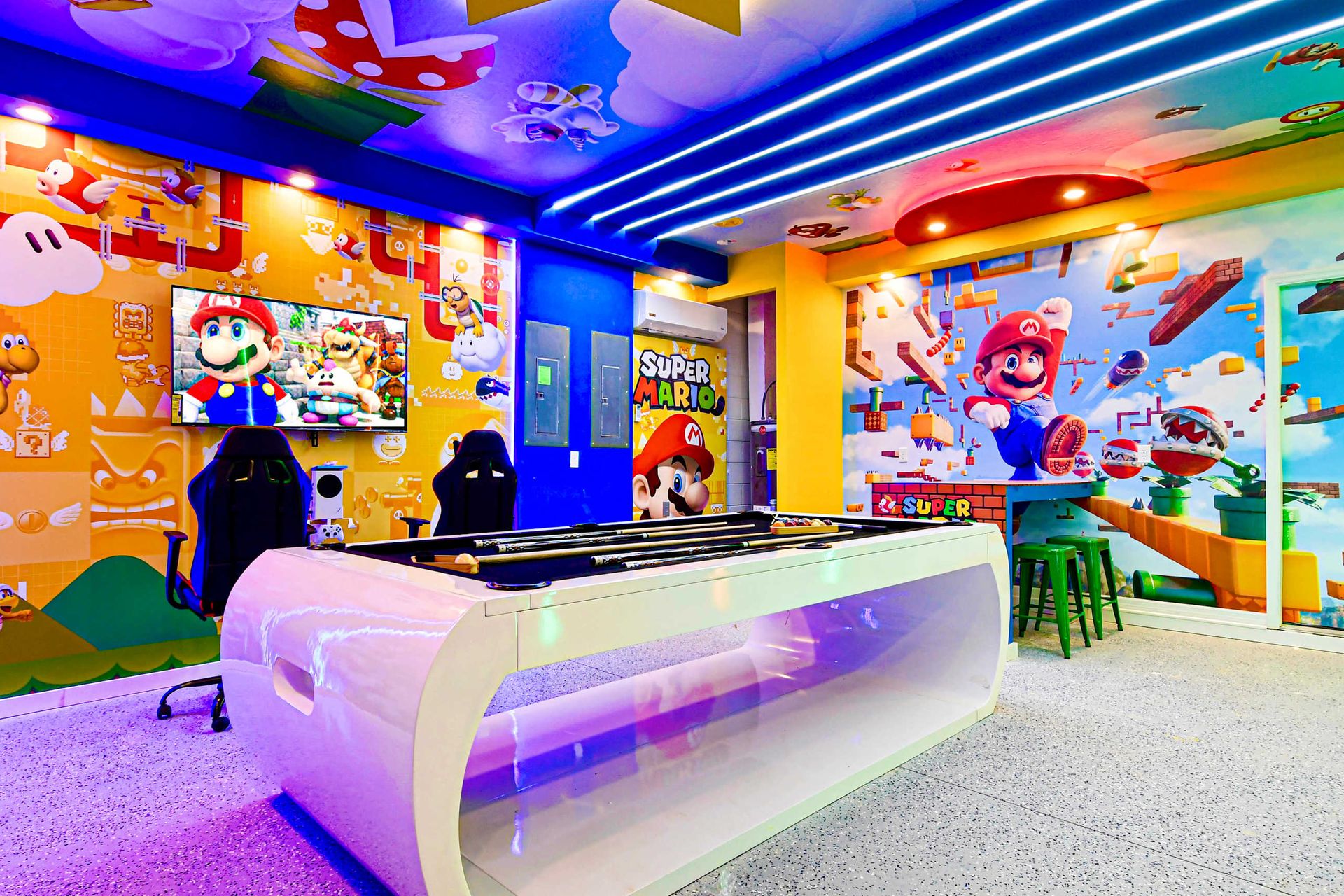 Immersive Super Mario game room with vibrant murals, pool, and gaming chairs!
